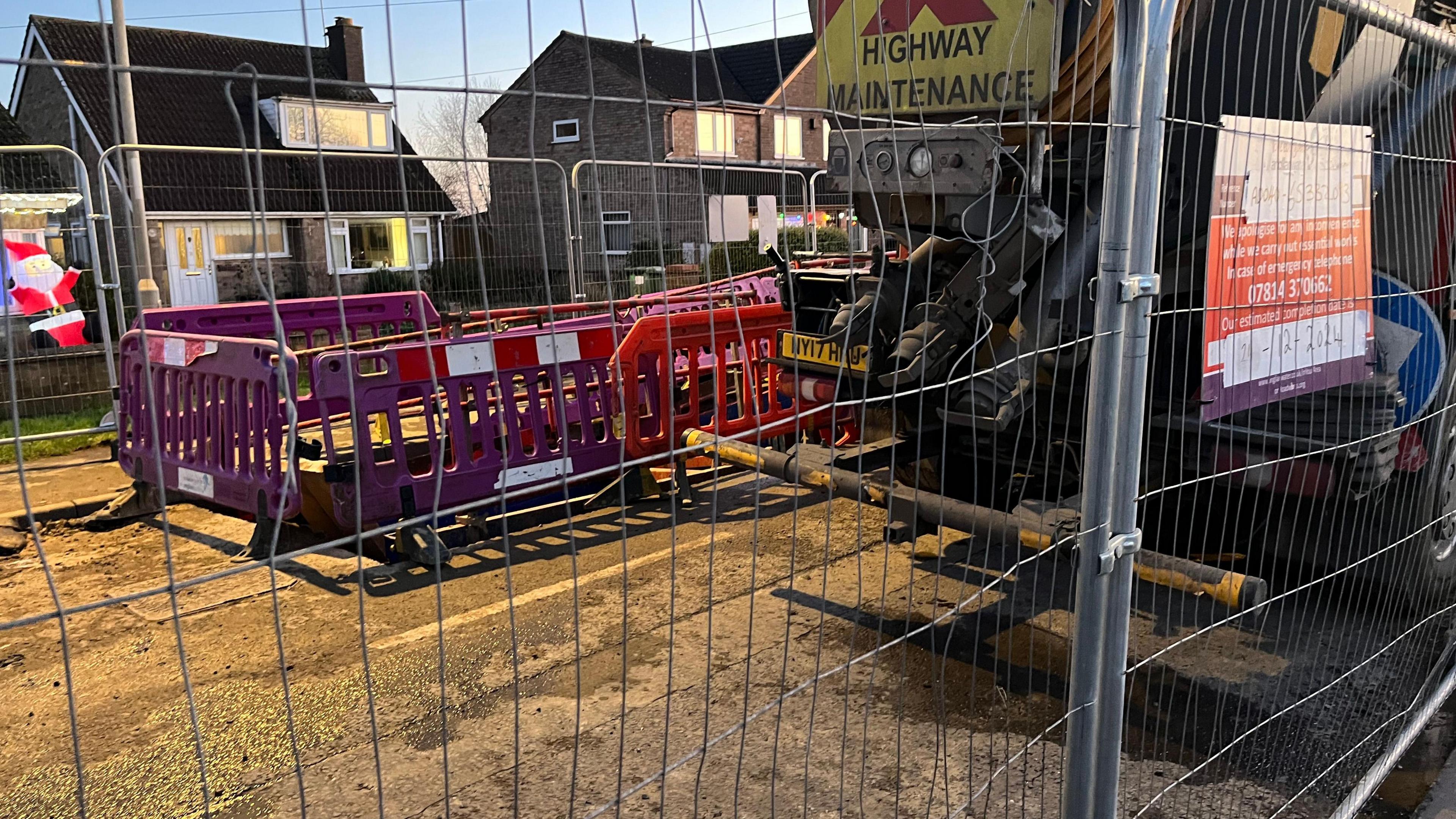 Work taking place on the site in Broadway. There are various fences positioned around a hole, with a lorry parked on site.