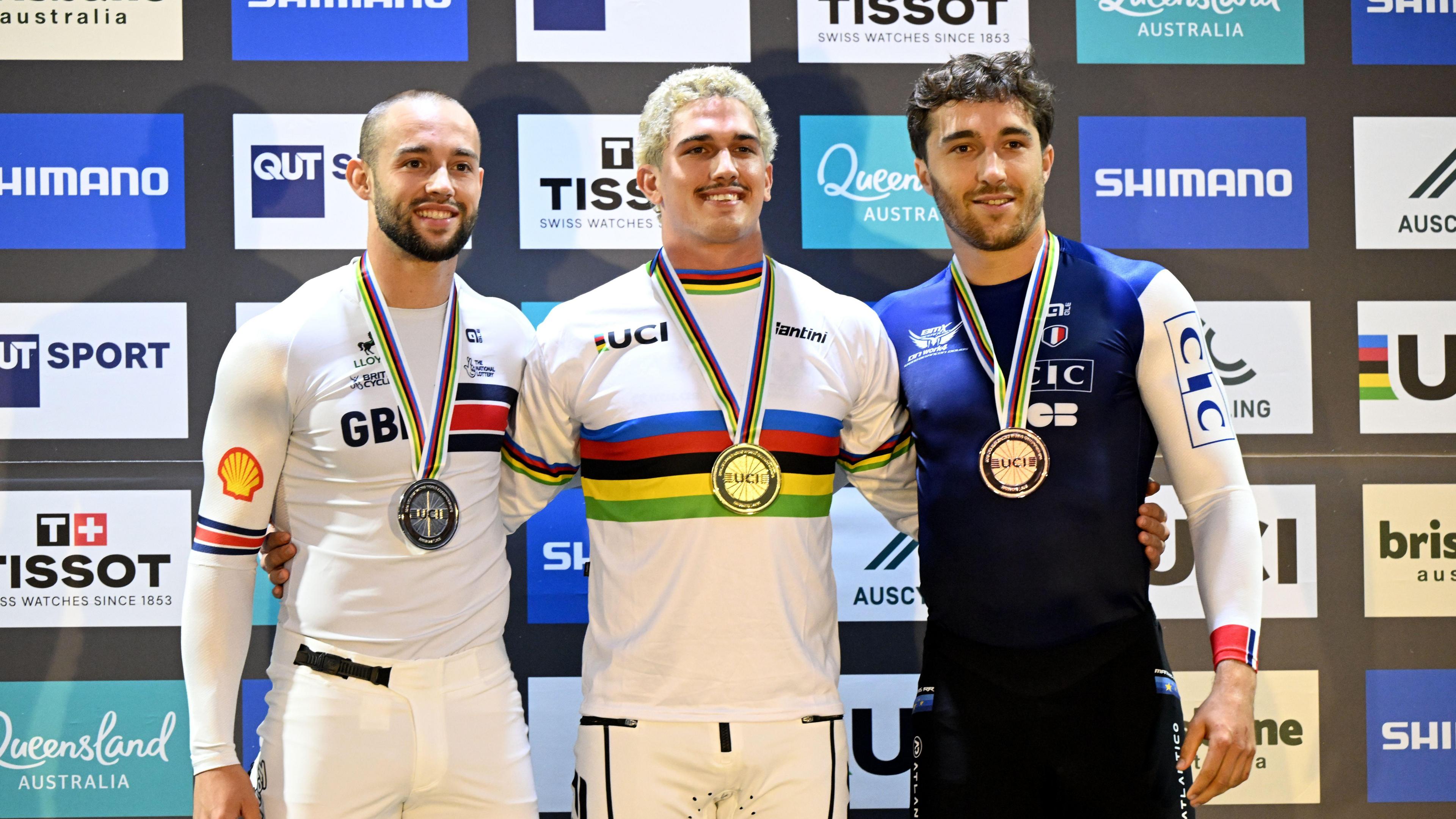 Men's Elite silver medalist Ross Cullen, gold medalist Jesse Asmus and bronze medalist celebrating on the podium.