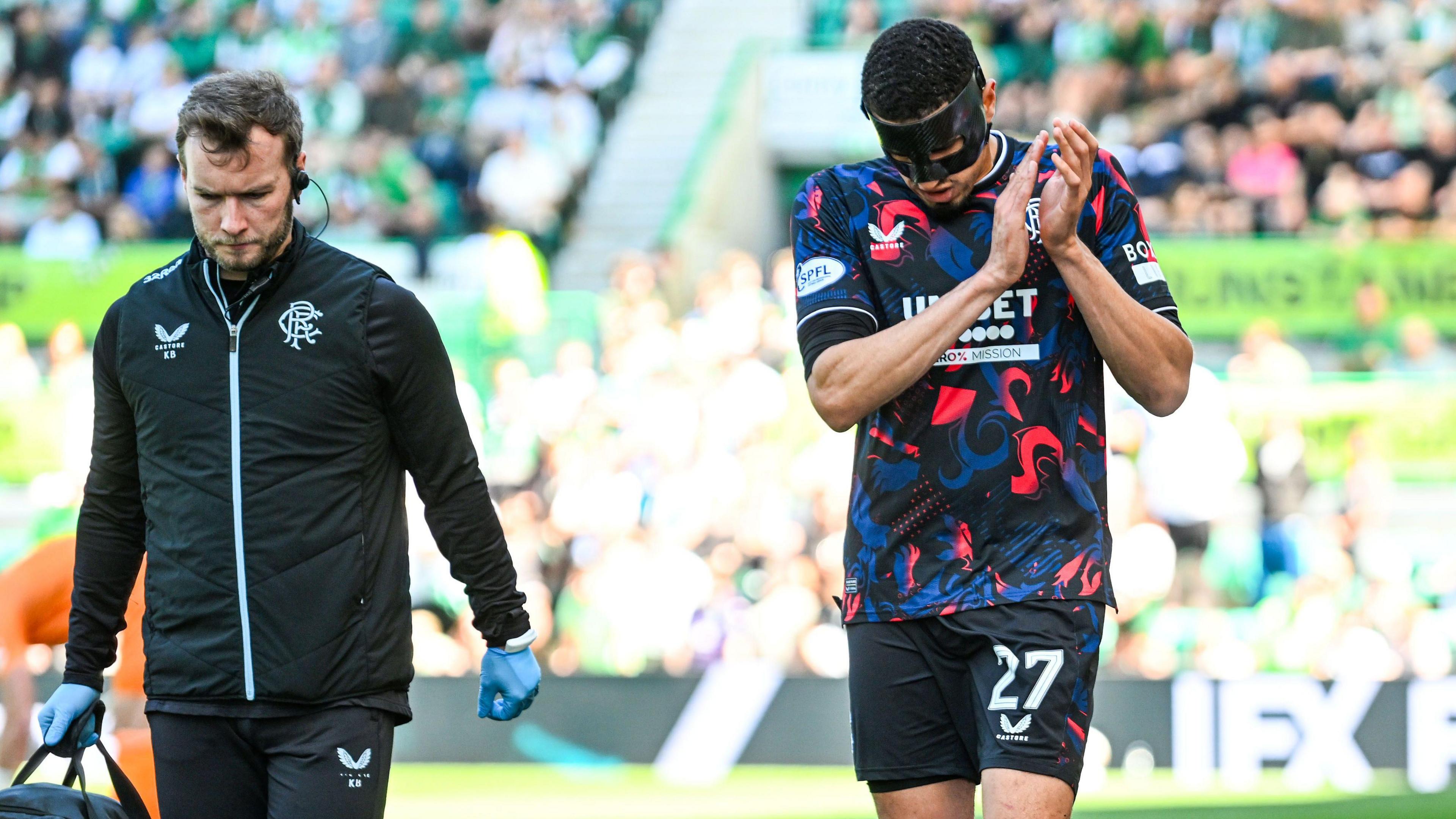 Rangers' Leon Balogun (right) goes off injured against Hibernian