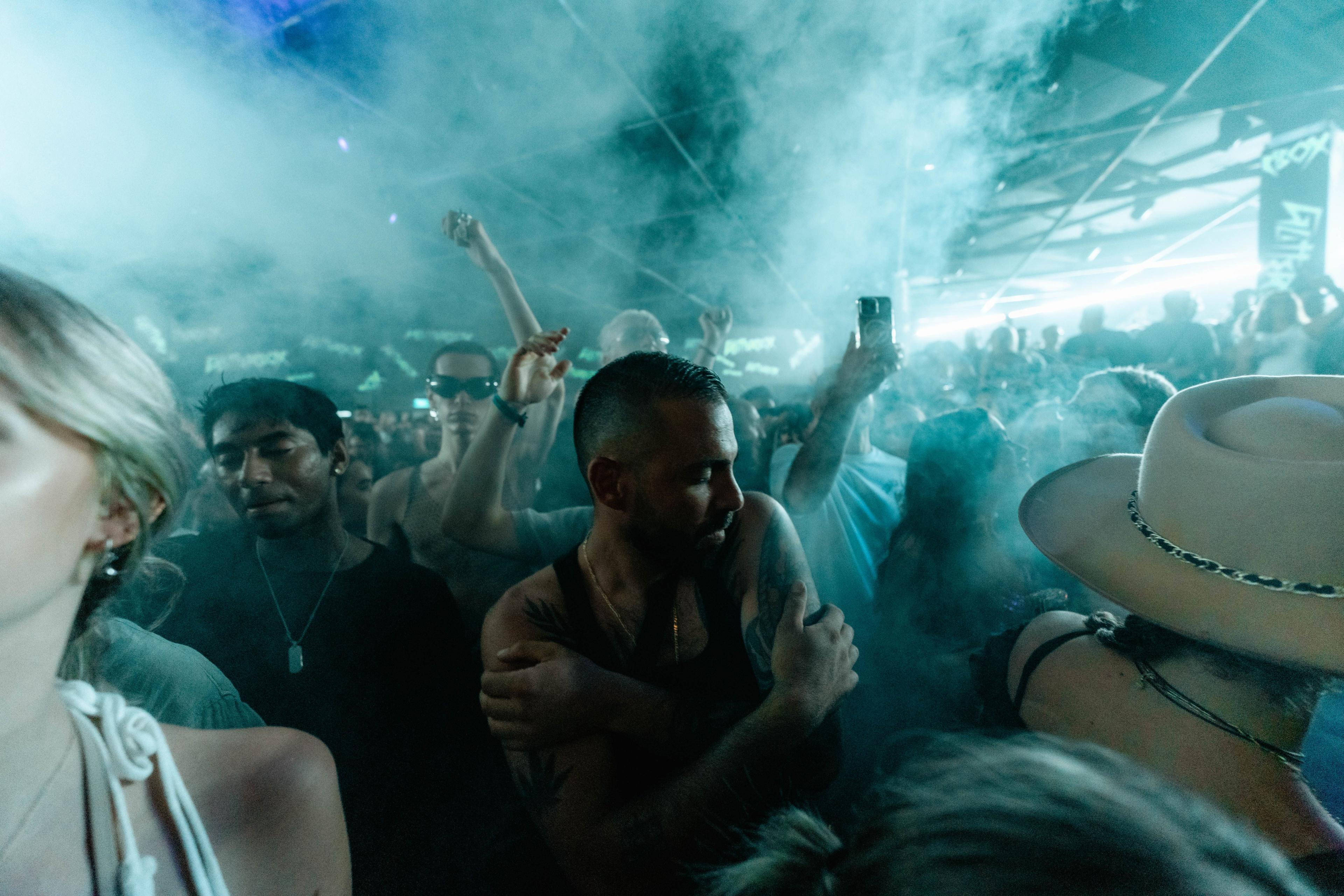 Smokey image of people dancing in a night club