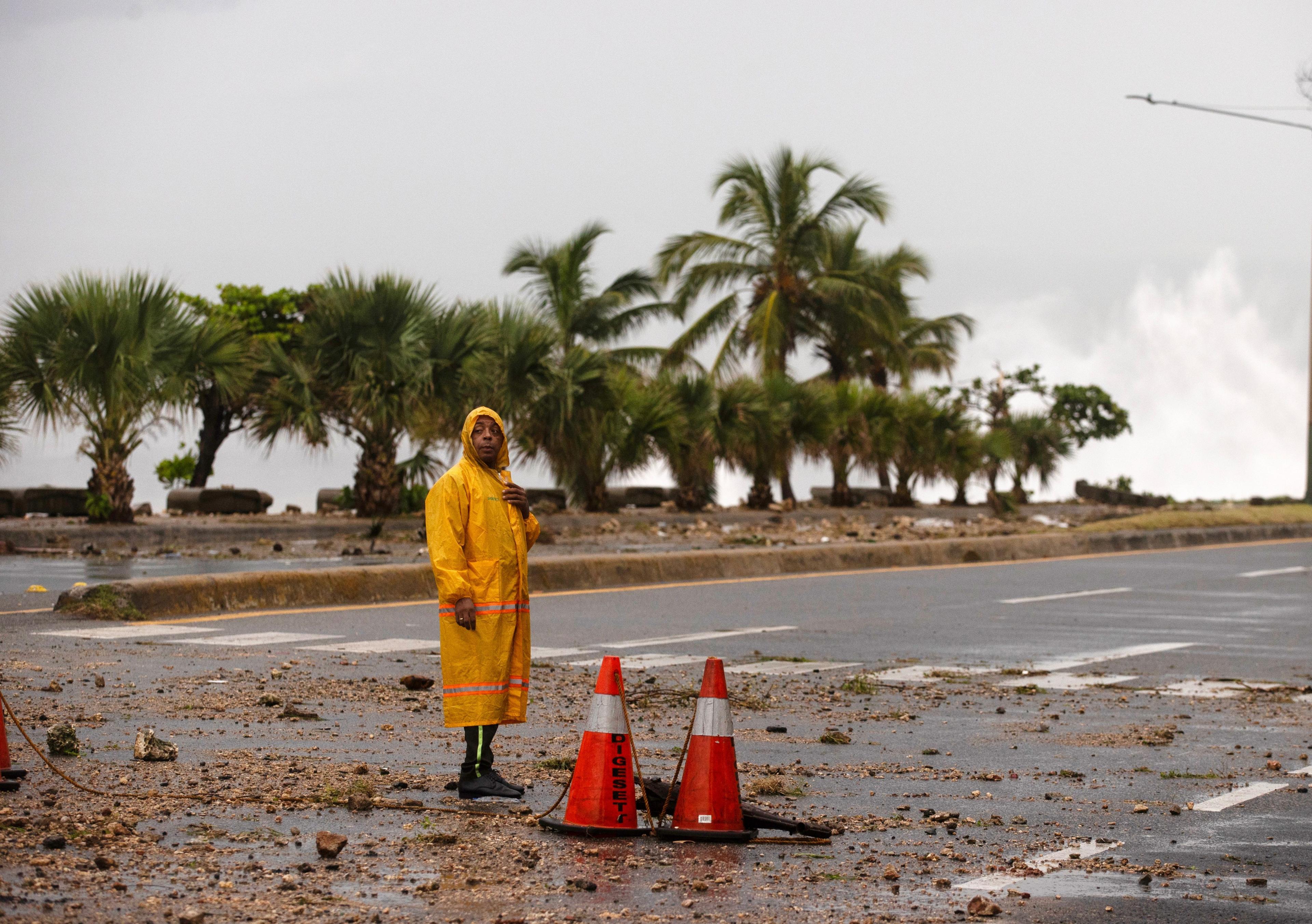 An agent blocks a road on the boardwalk of Santo Domingo, Dominican Republic