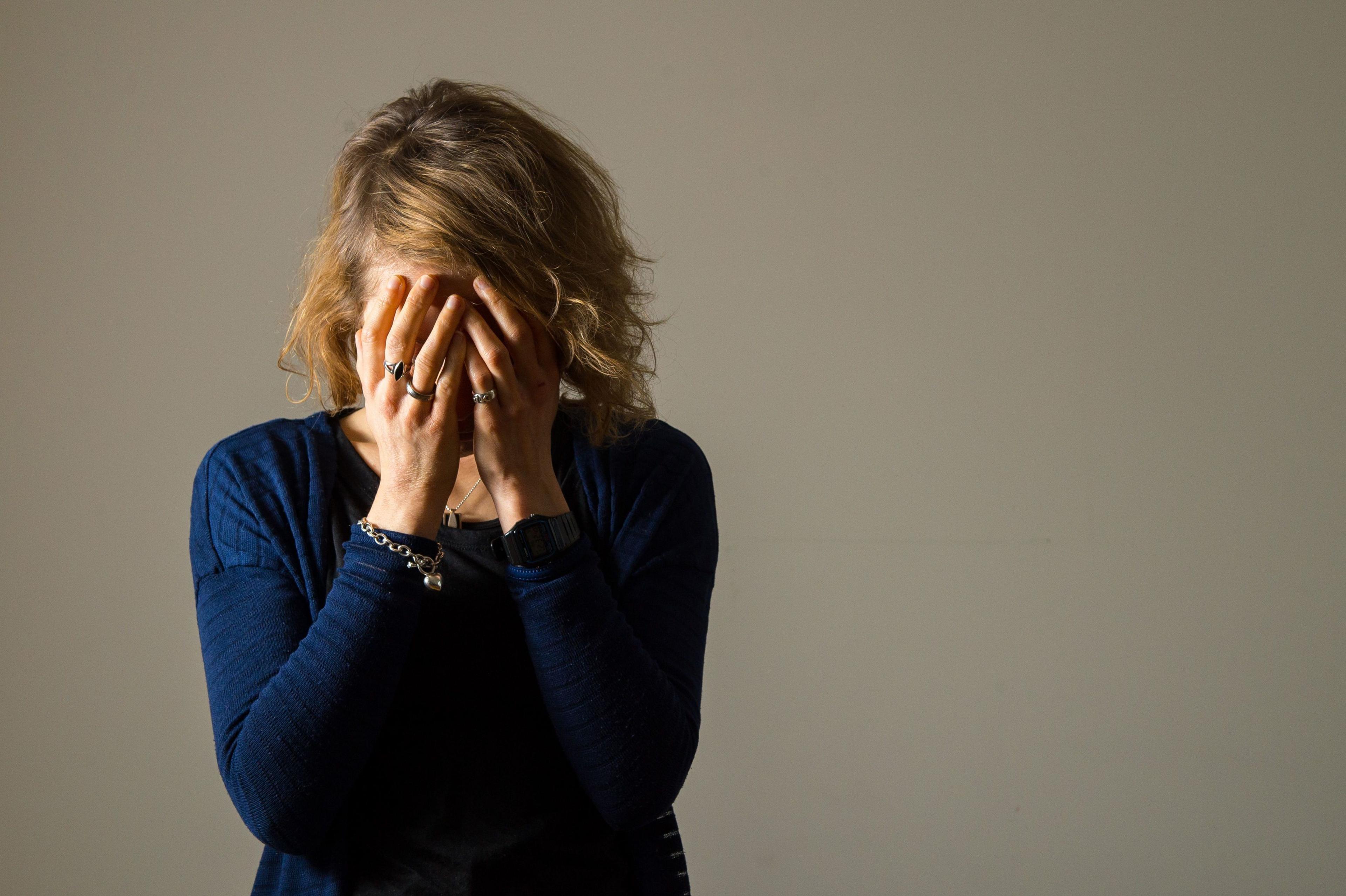 A woman with her hands on her face 