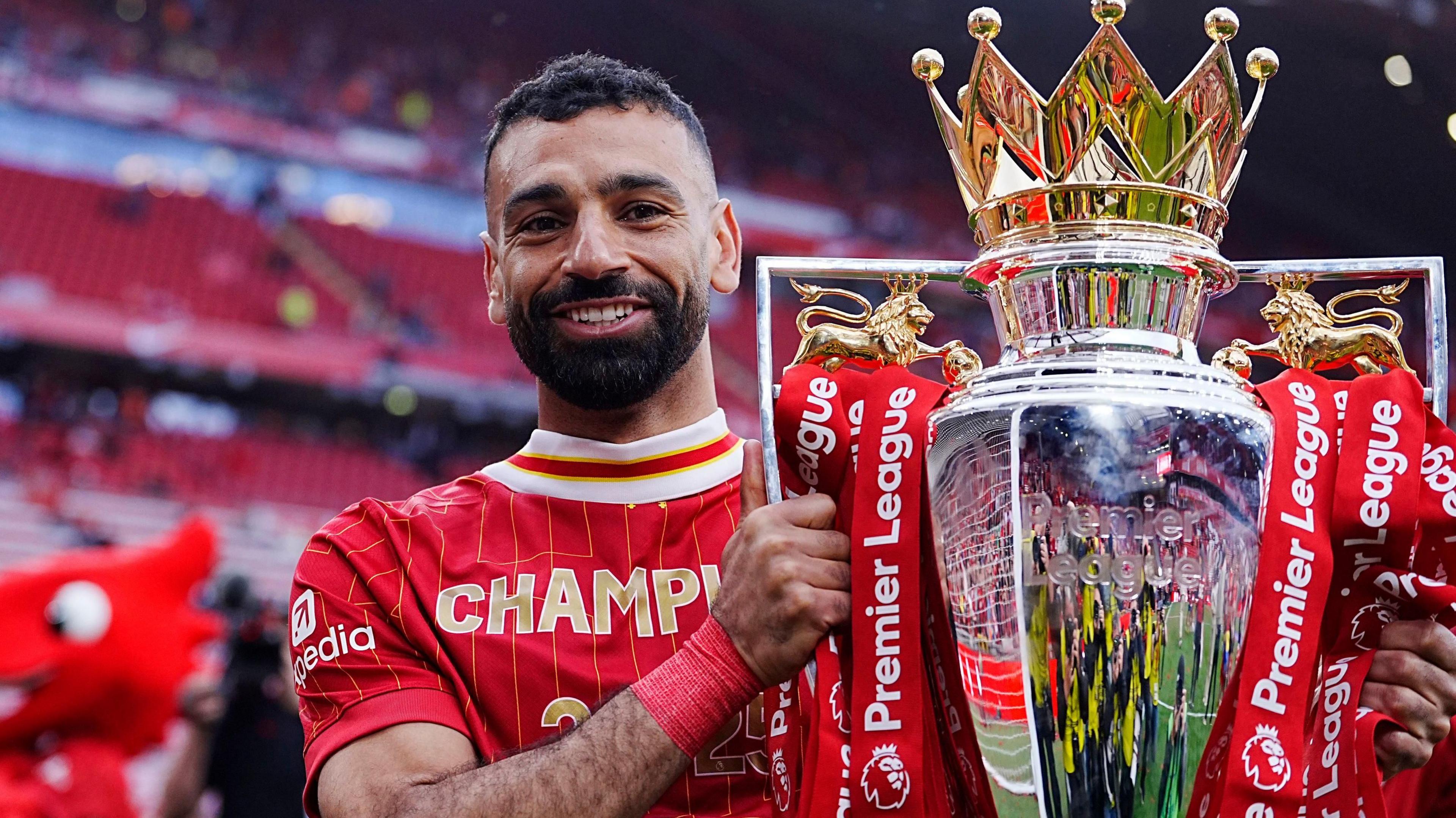 Mohamed Salah holds the Premier League trophy