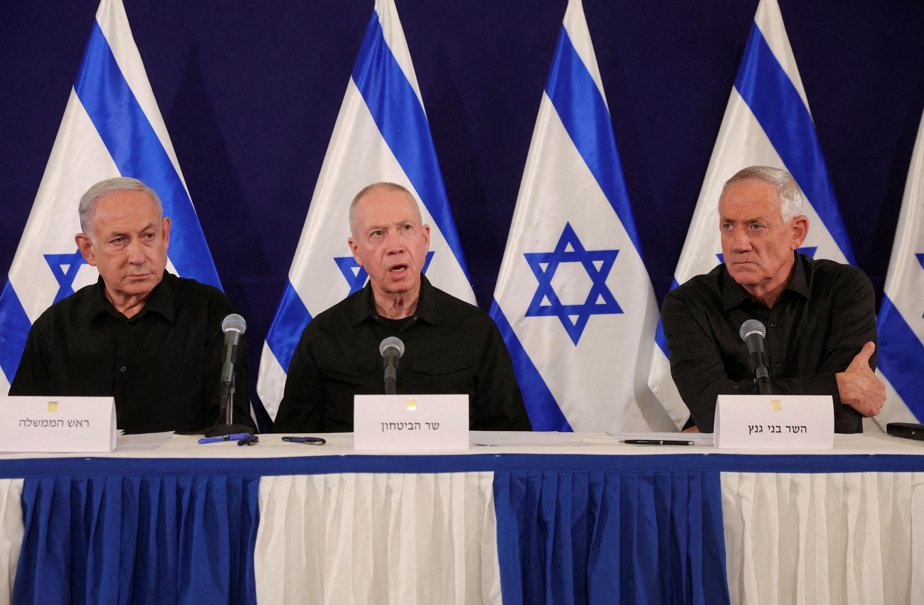  Israeli Prime Minister Benjamin Netanyahu, with Defense Minister Yoav Gallant and Cabinet minister Benny Gantz, holds a press conference in the Kirya military base in Tel Aviv,