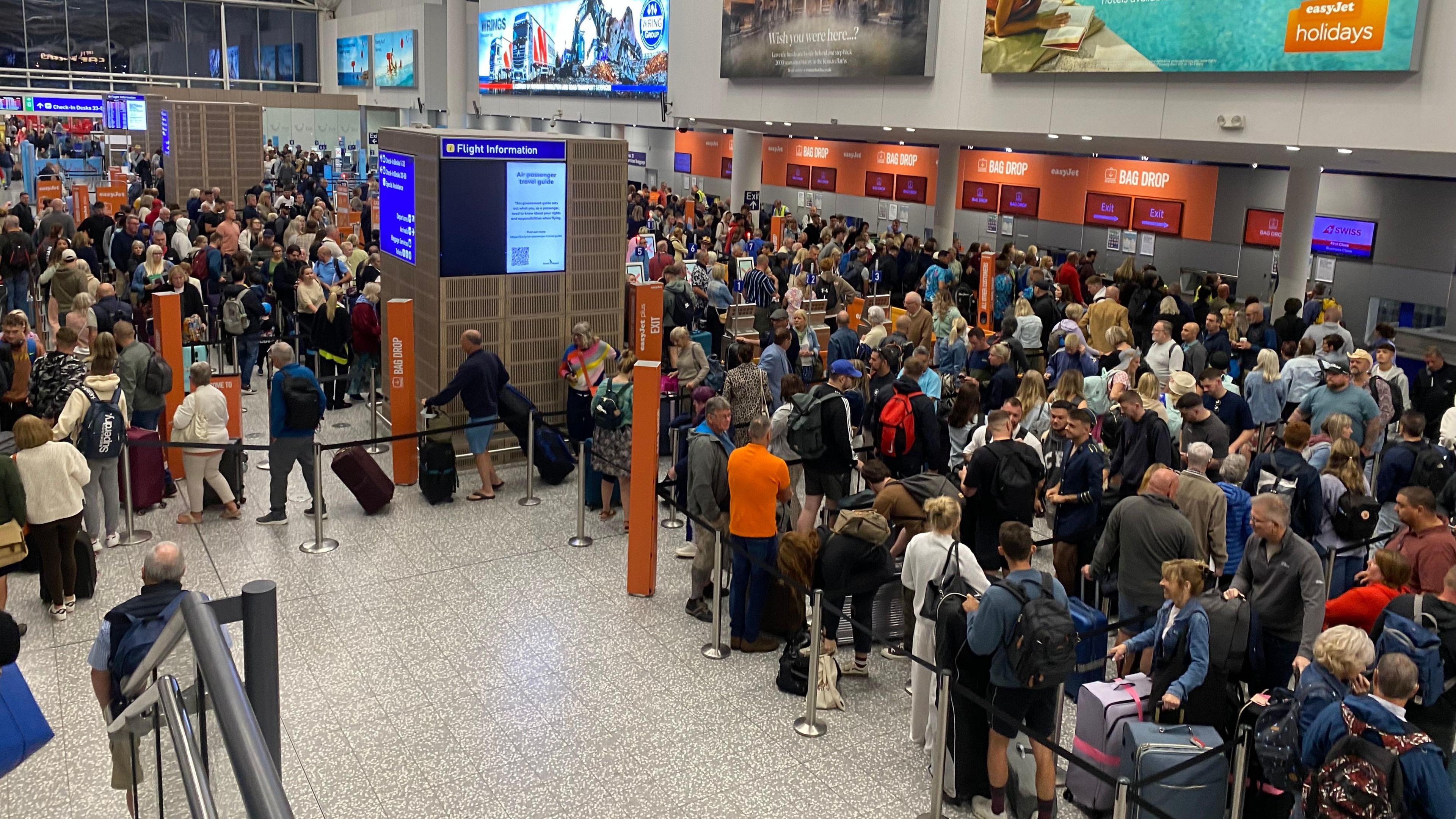 Long queues and crowds at EasyJet desks at Bristol Airport.