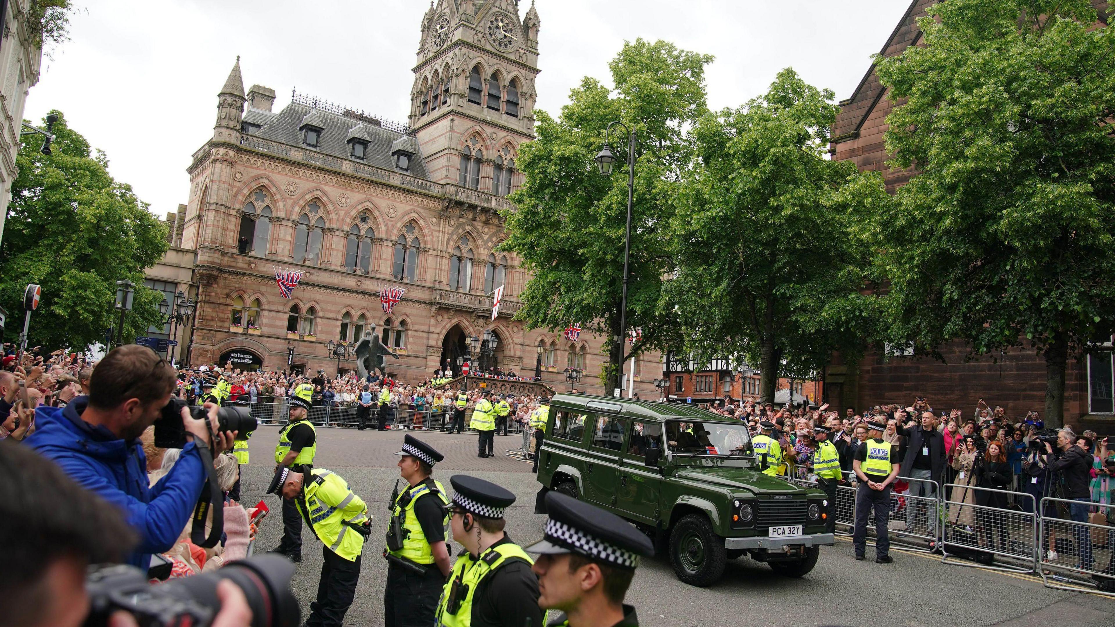 Photographers and crowds of people watch as a car arrives at the wedding of Hugh Grosvenor, the Duke of Westminster, to Olivia Henson at Chester Cathedral