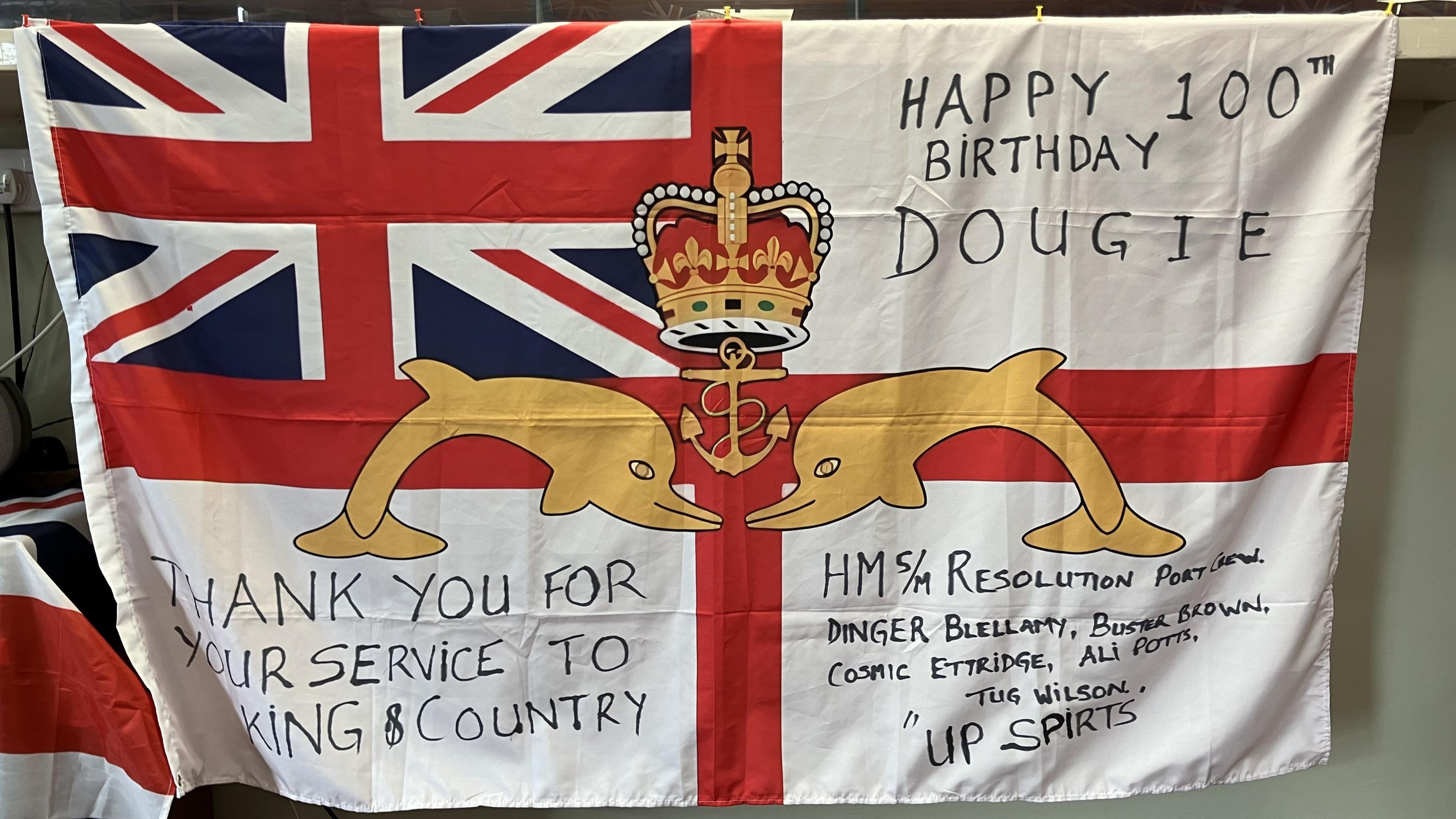 Flag shows draped naval ensign and marker additions including"thank you for your service to King and country"