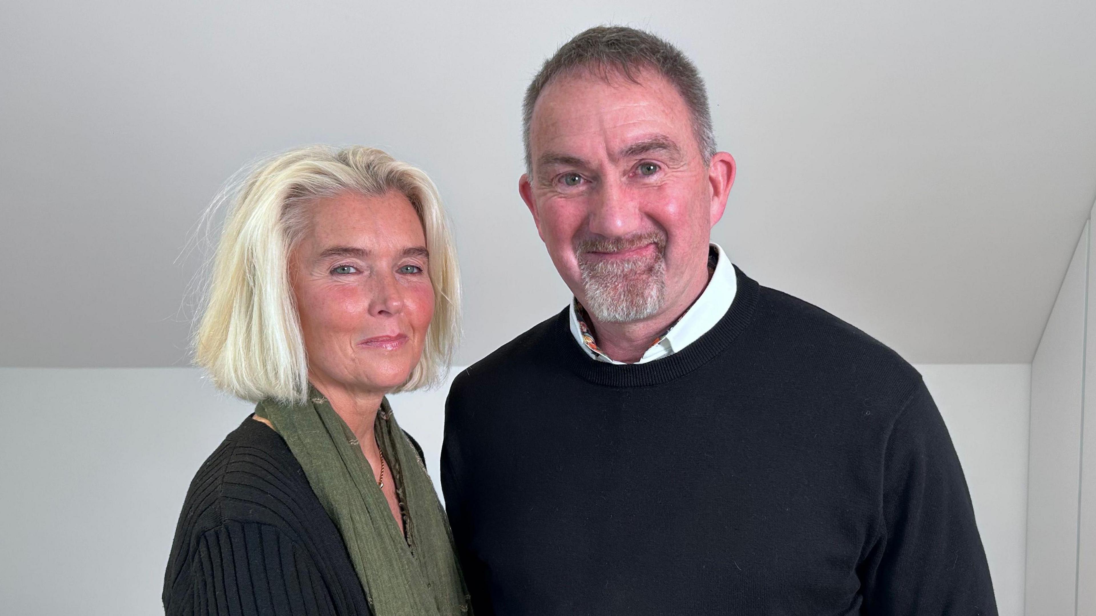 Helen and Jason Forskitt stand side-by-side and are smiling at the camera.