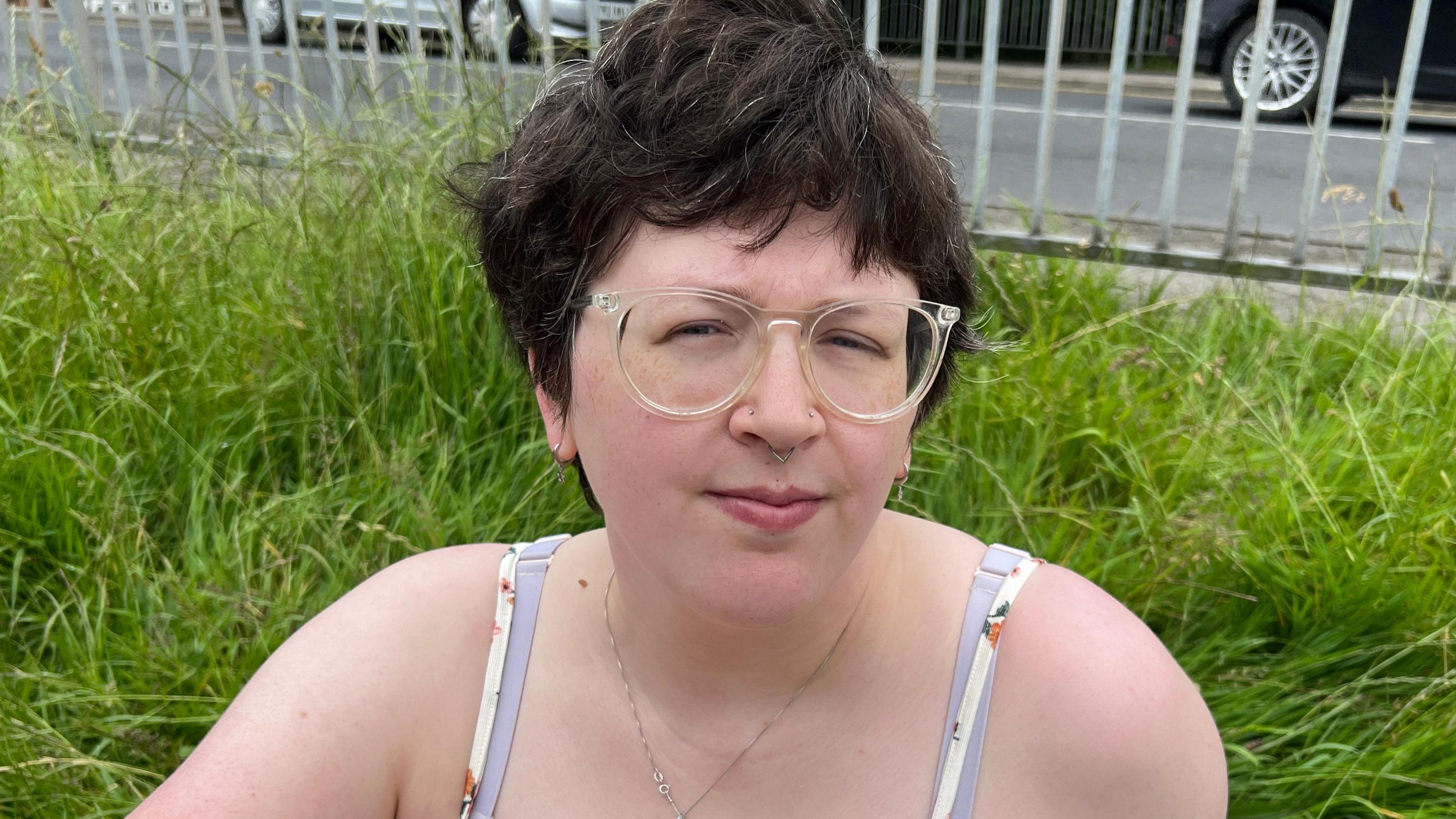 Jude Wright is pictured in a summer dress on a spot of grass near Selby bus station