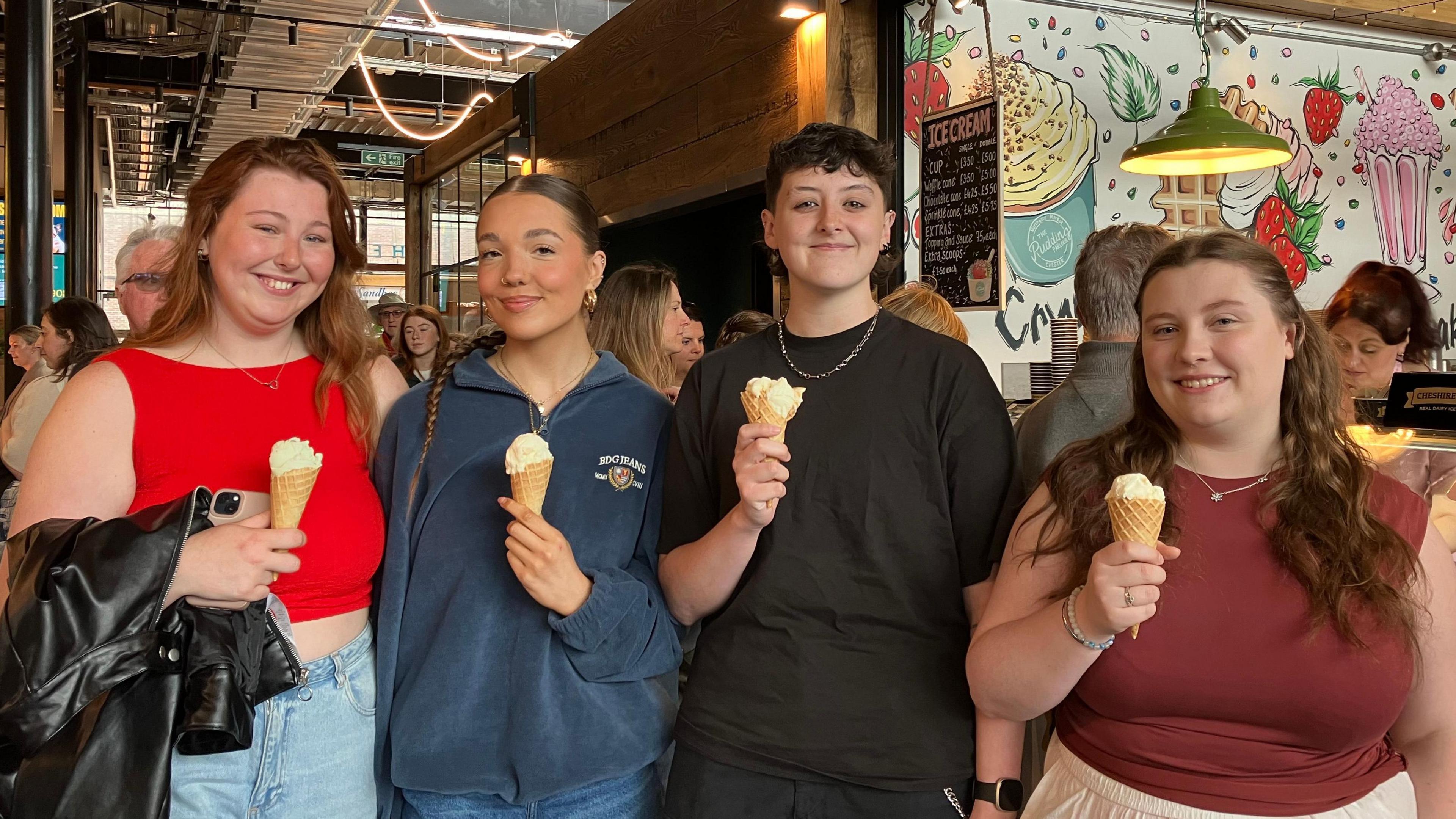 Four students friends with their free ice creams