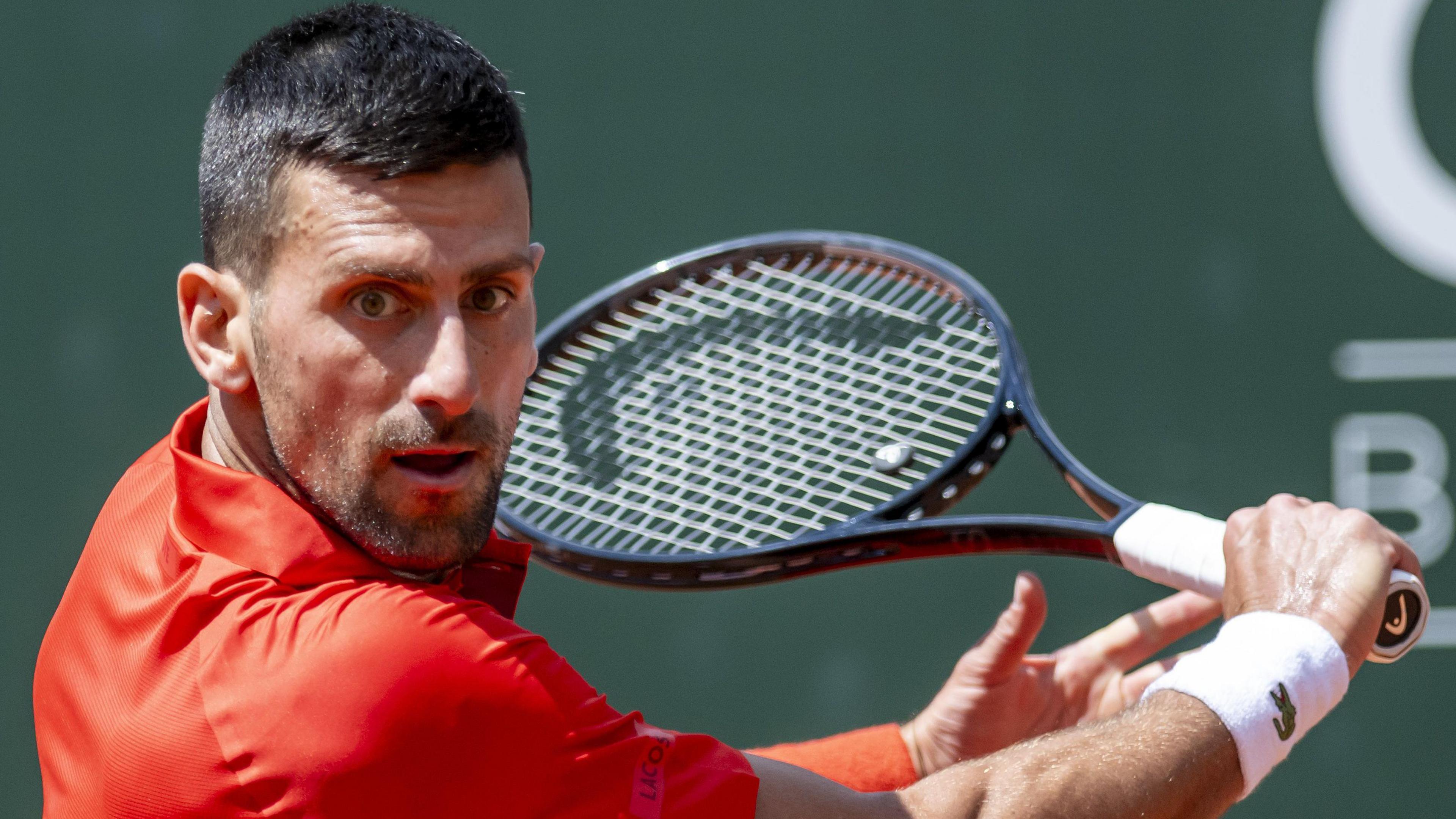 Novak Djokovic hits a backhand return during his Geneva Open semi-final match