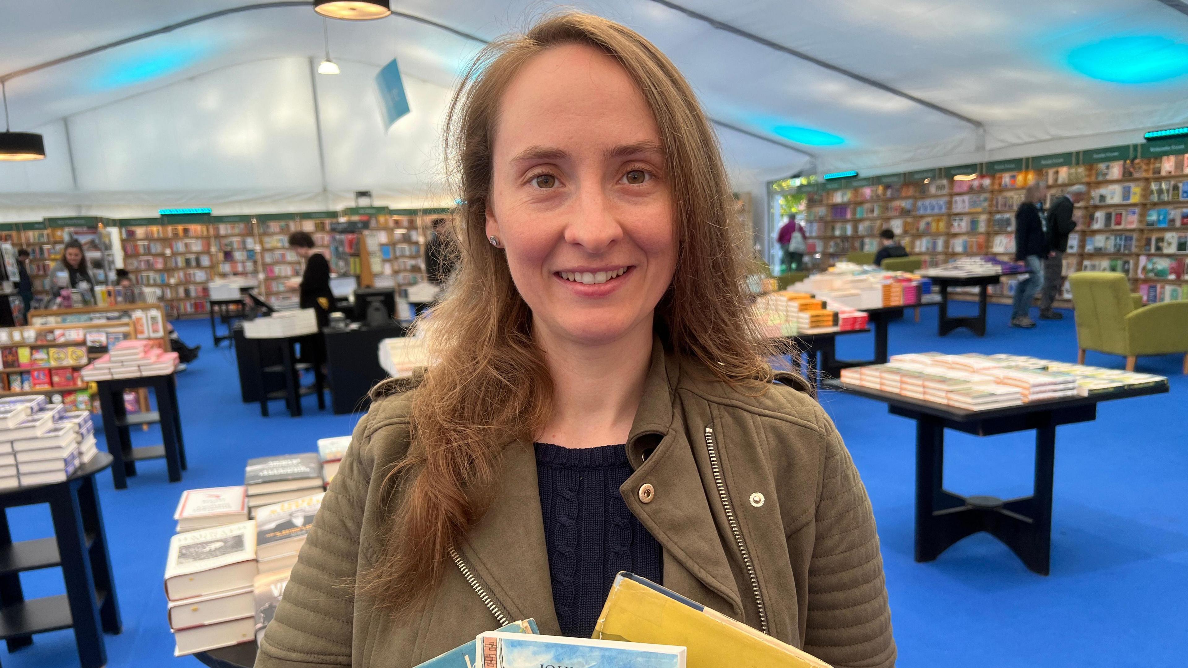 Kirstie Bingham holding books at Cheltenham Literature Festival