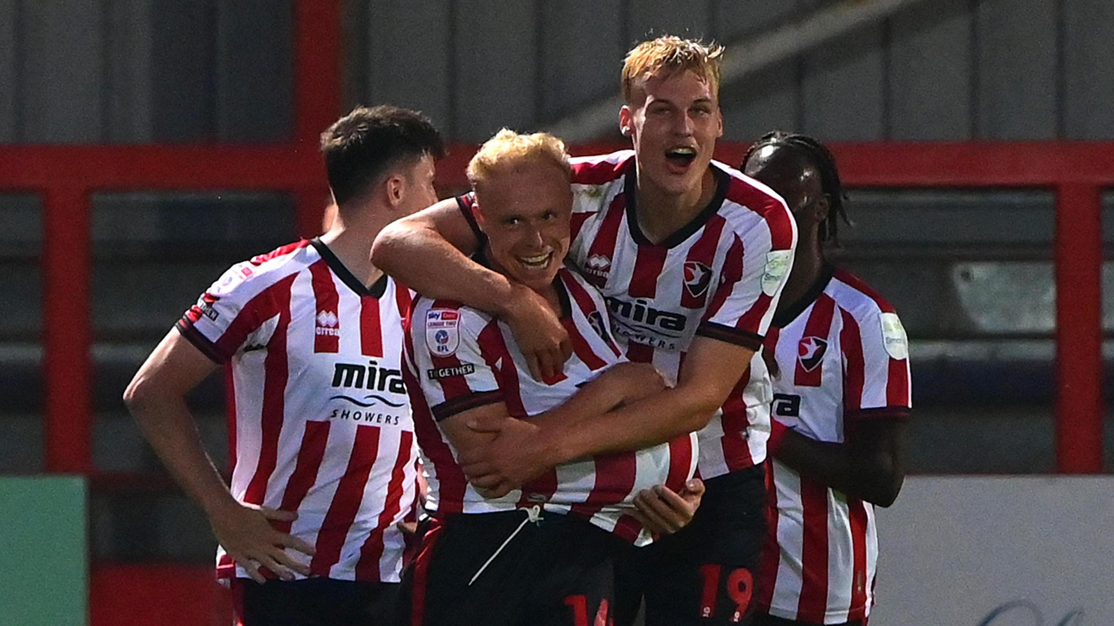 Cheltenham players celebrate their second goal