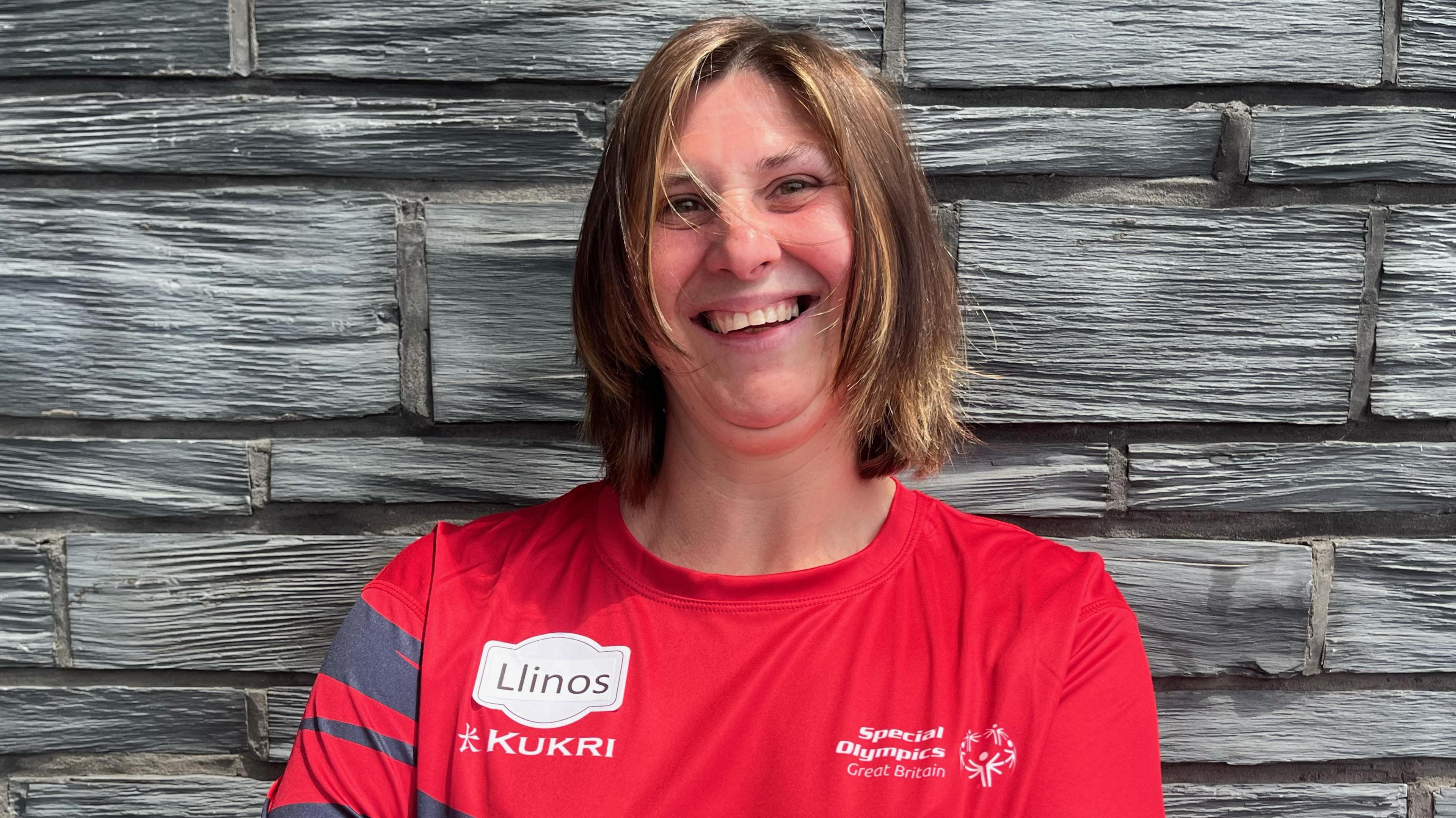 Llinos Jones stood outside the Senedd with her arms crossed