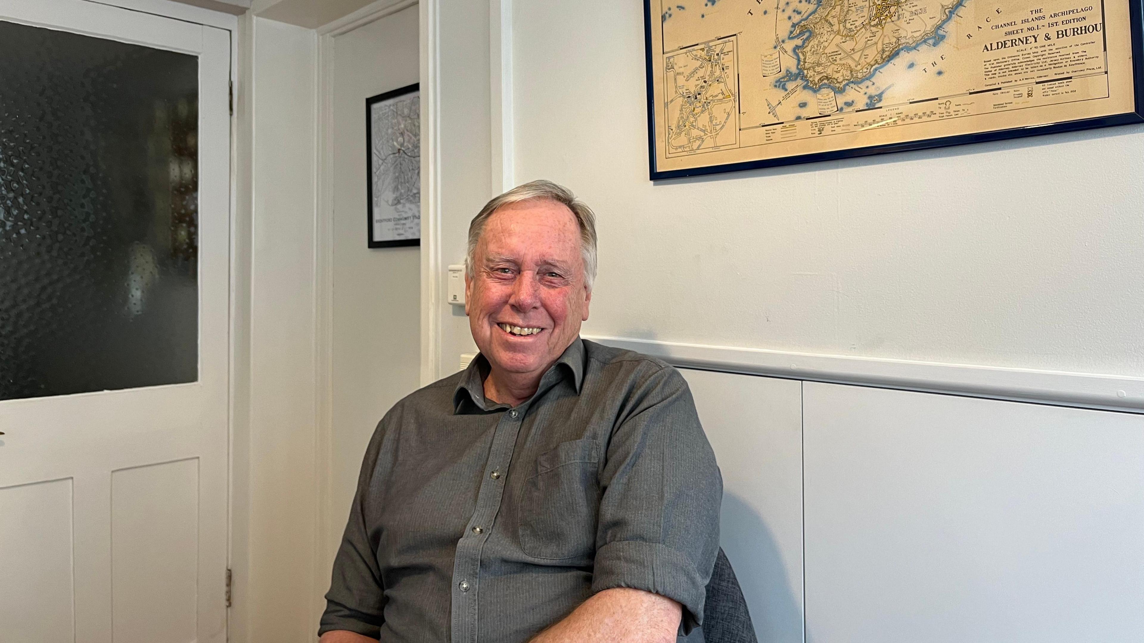 Andrew Eggleston wearing a grey shirt and smiling at the camera