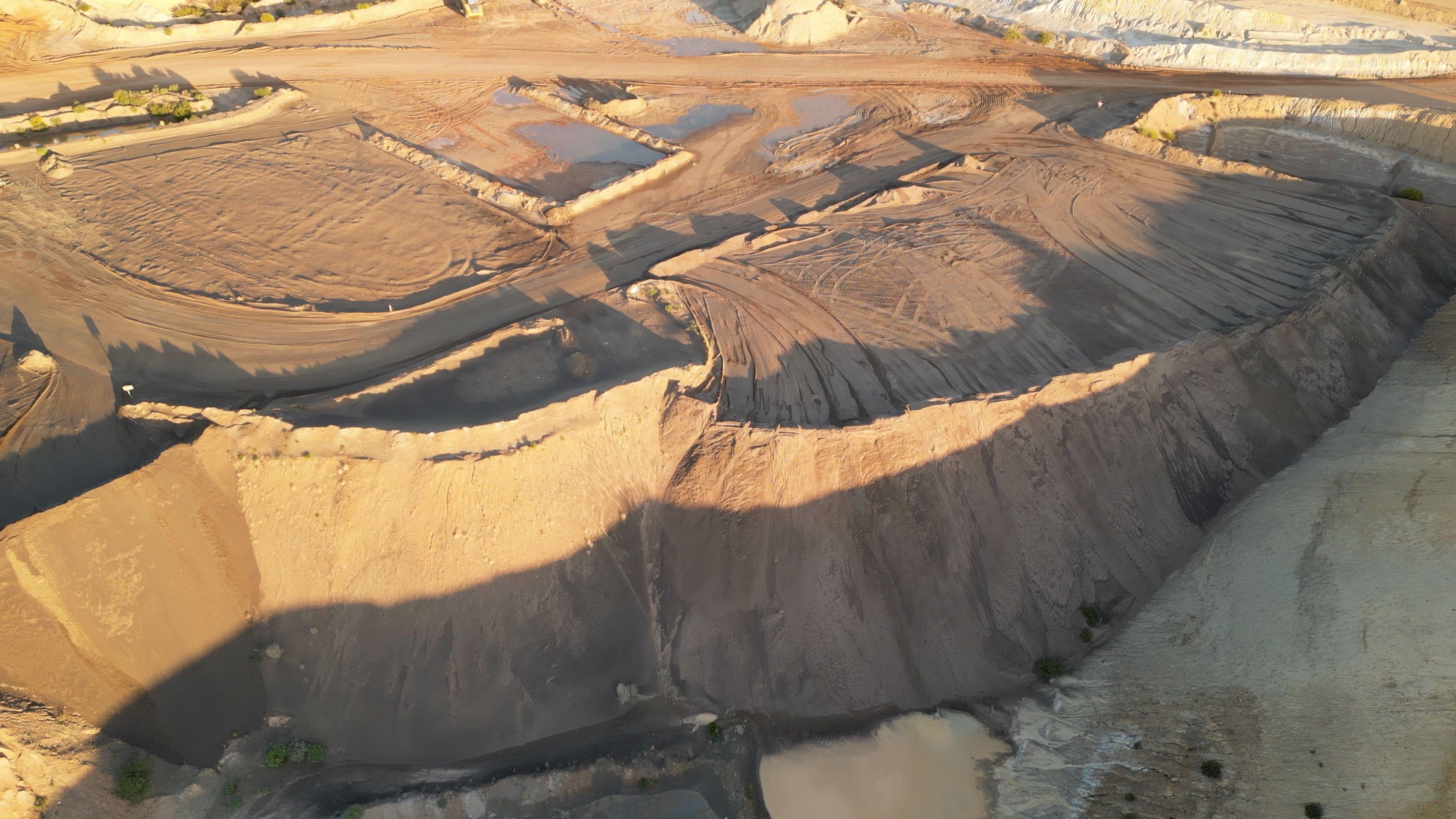 Iluka Resources stockpile can be seen from above. It looks like piles of sand in what appears to be a rocky desert.