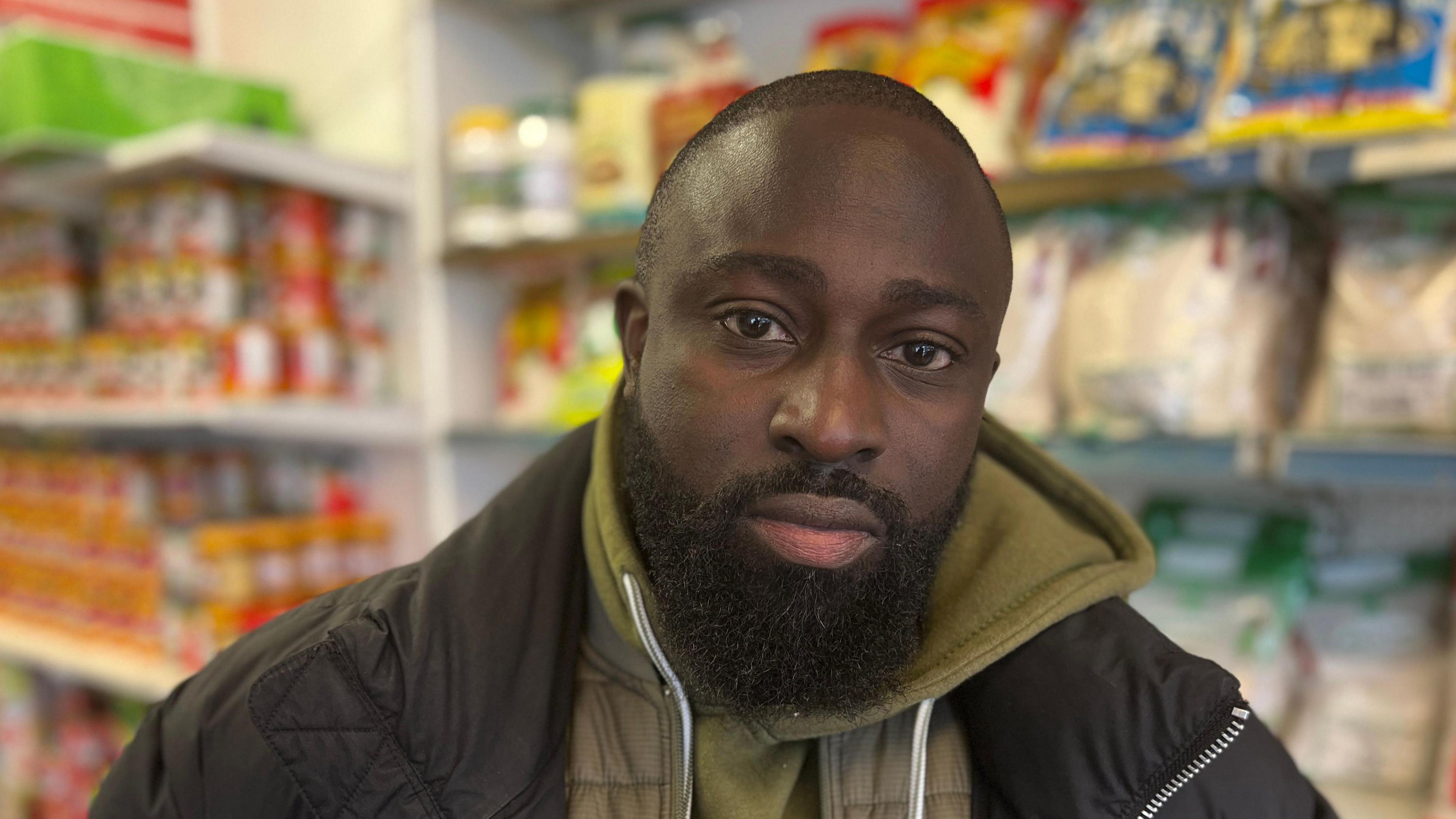 Richard Bonsu wearing a green hooded top and a black jacket on top