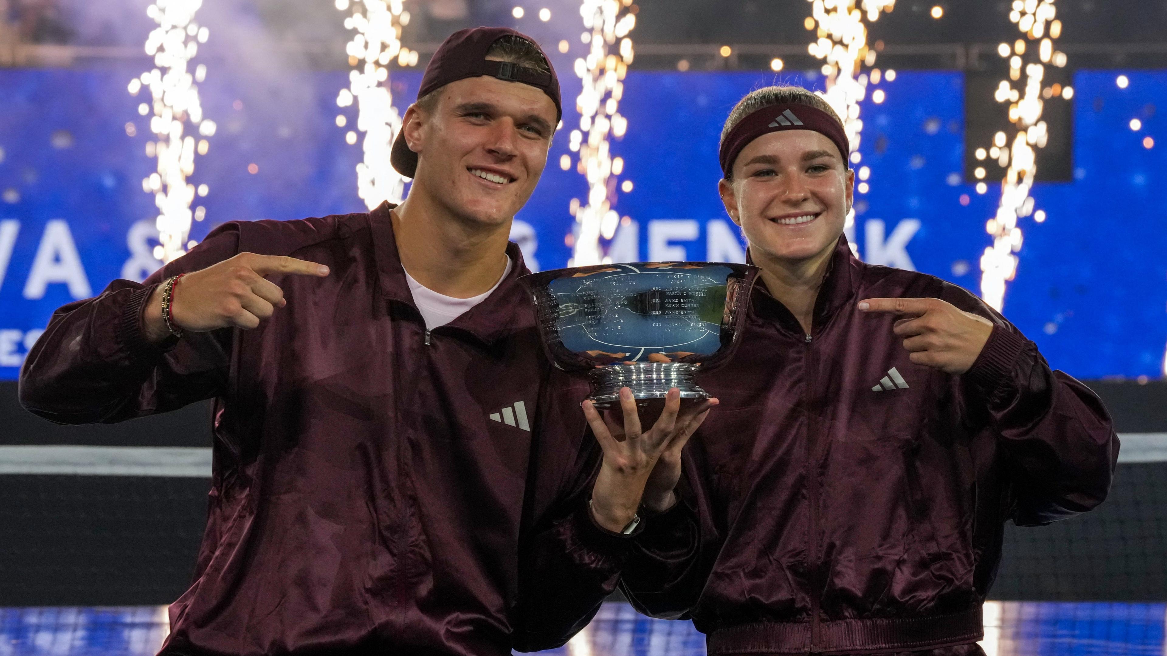 Jakub Mensik and Karolina Muchova point at the US Open trophy