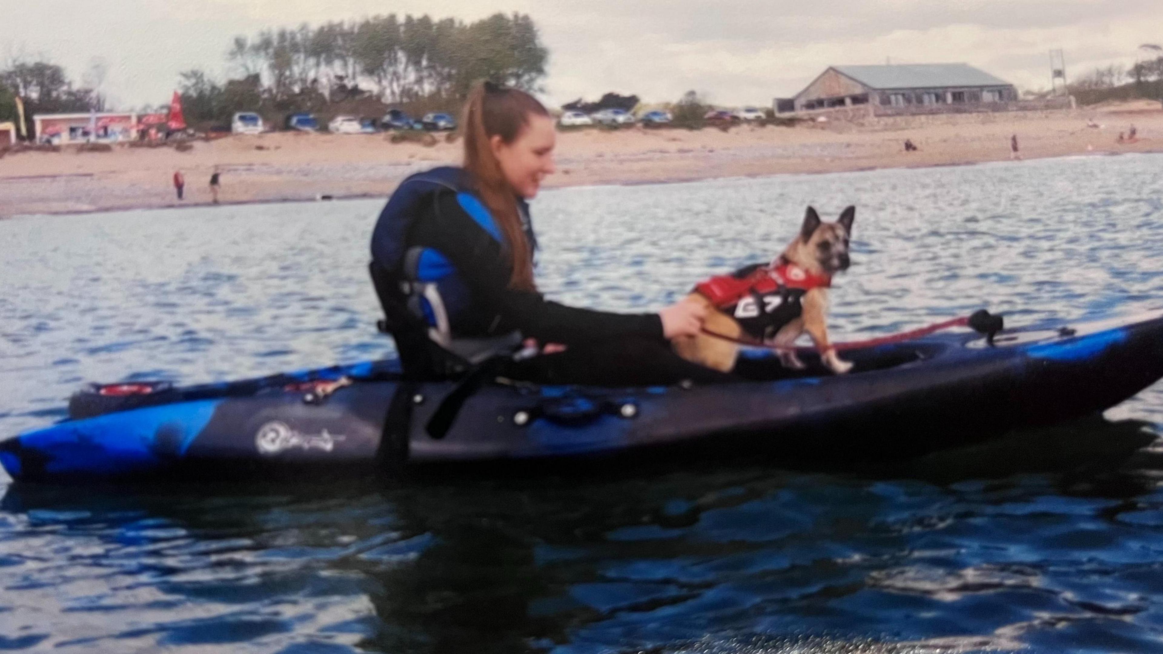 Morgan and her small dog Peaches on a kayak