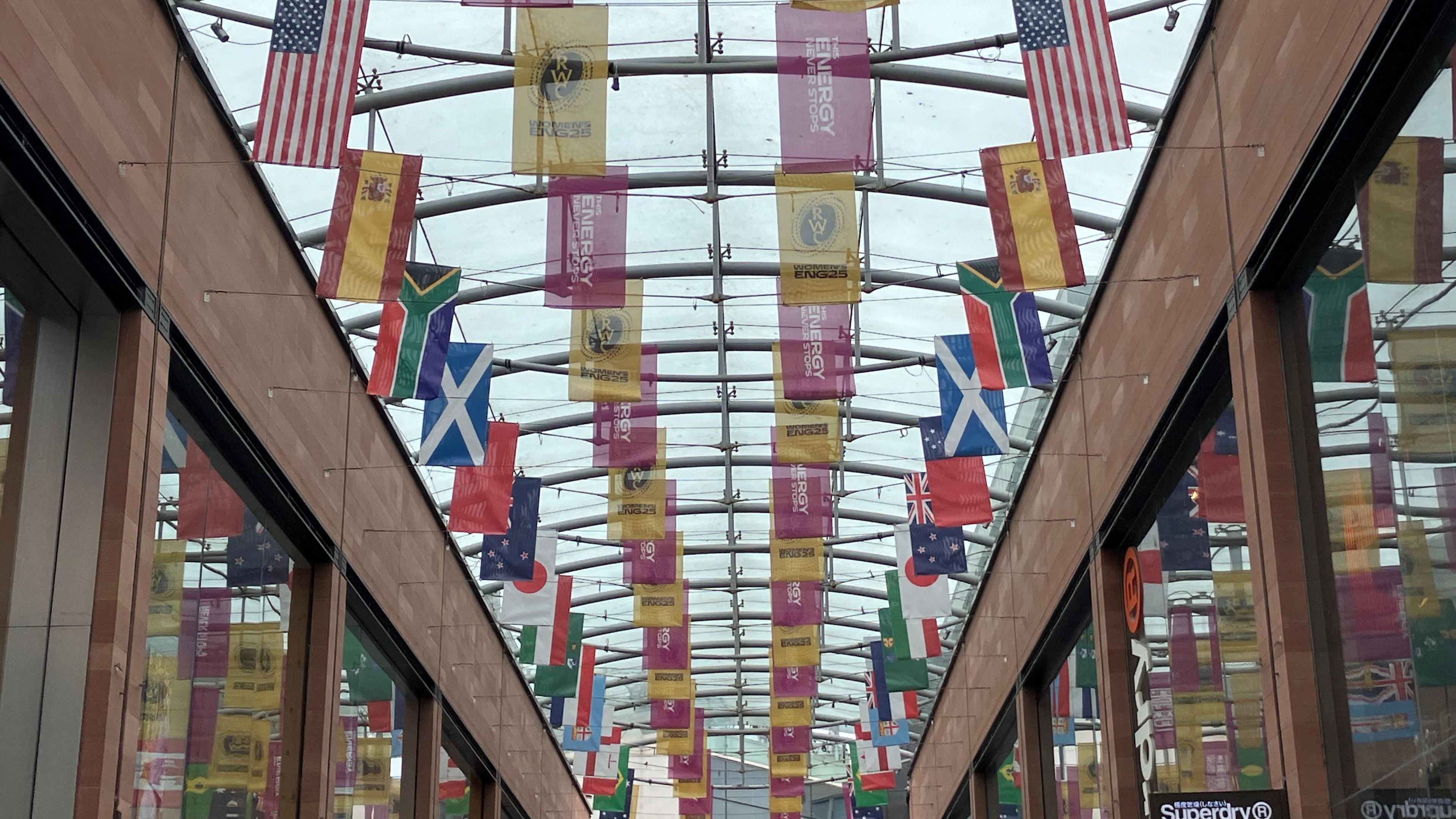 Various national flags hung from the ceiling of a shopping centre in Exeter.