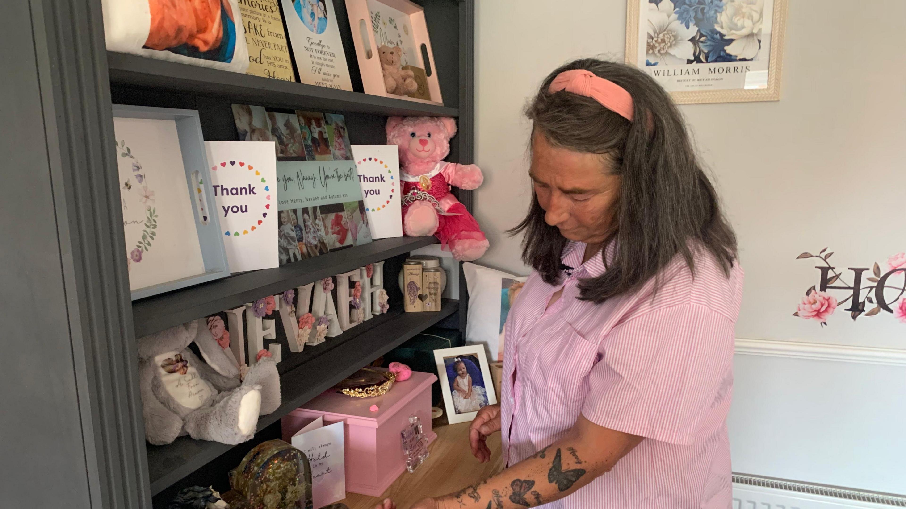 Claire holding a photo of Nevaeh