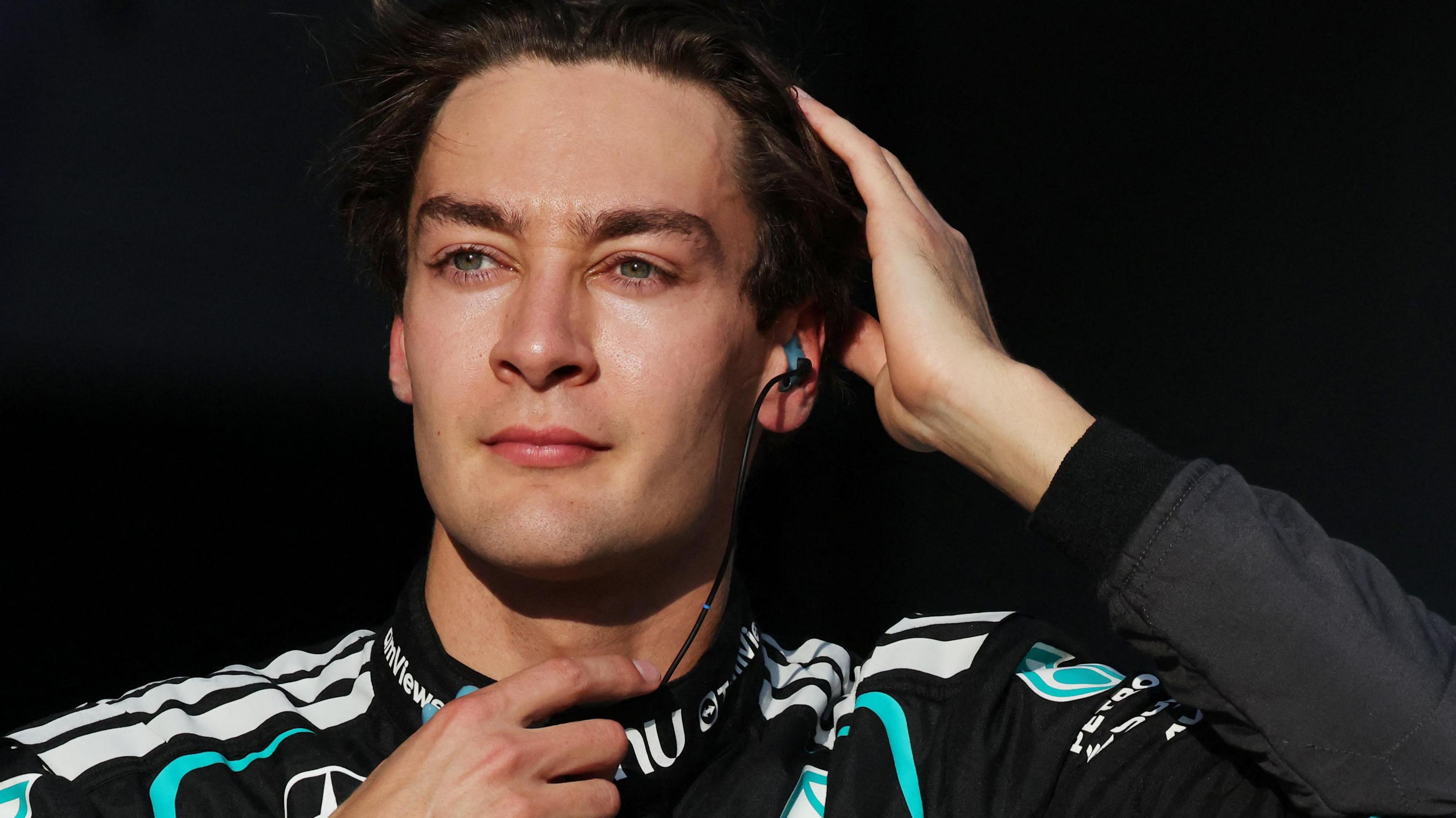 George Russell runs his right hand through his hair as he prepares for the start of the 2026 Japanese Grand Prix