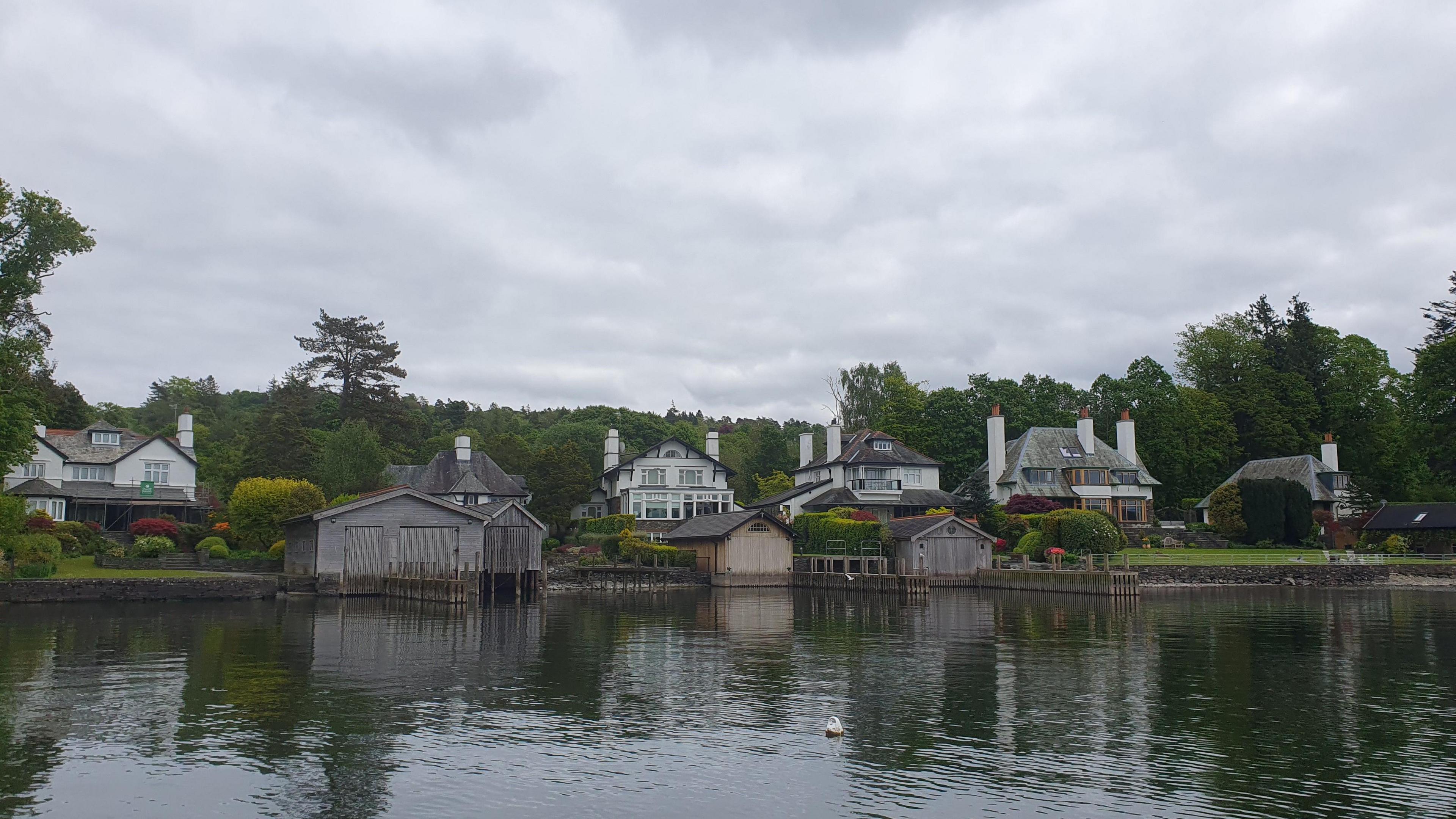 A general view of the Windermere Villas area. There are large houses on the shores of the lake, some with boathouses.