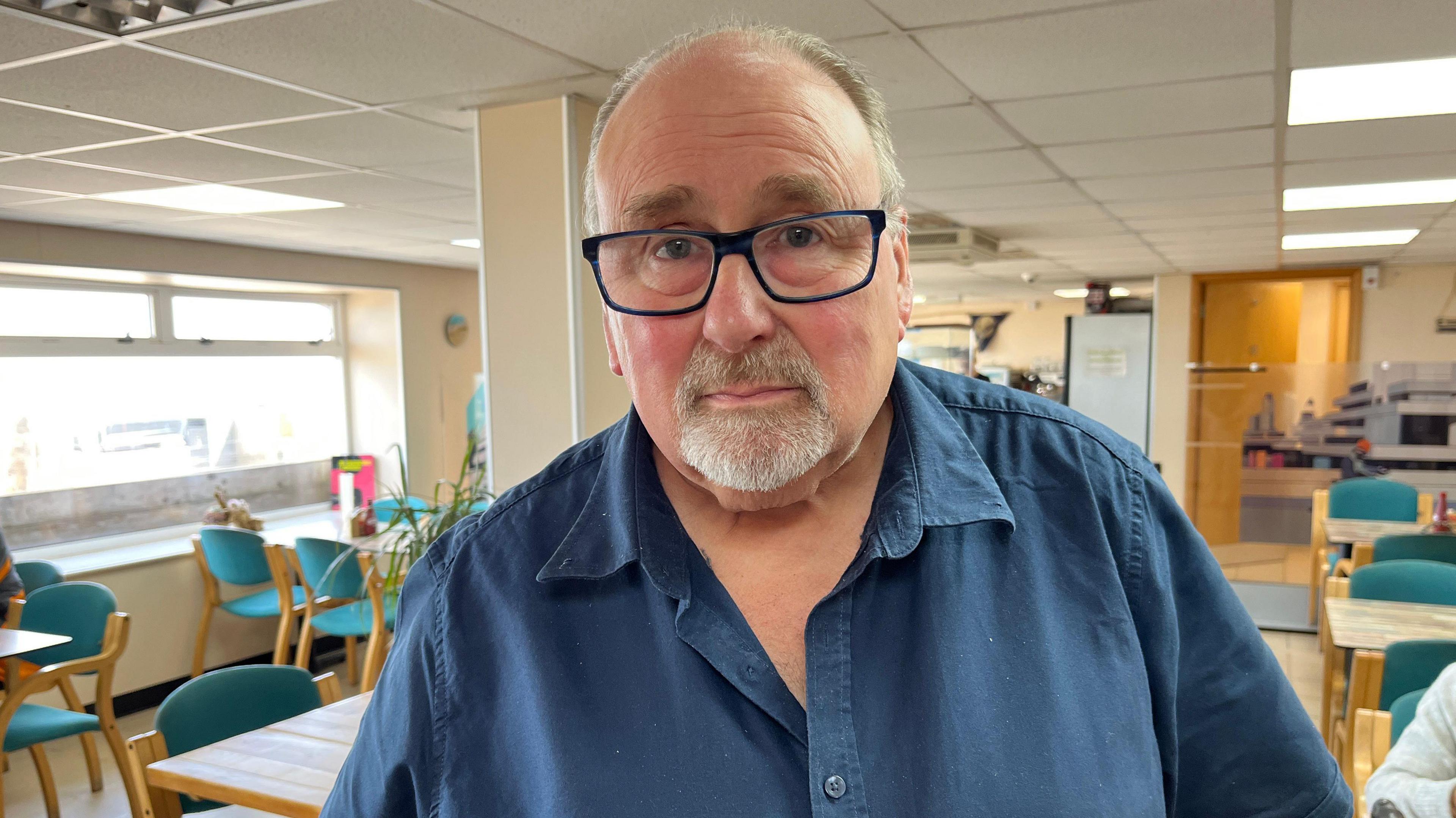 Graham French with tables behind him at the Kingfisher Cafe on Walcott seafront