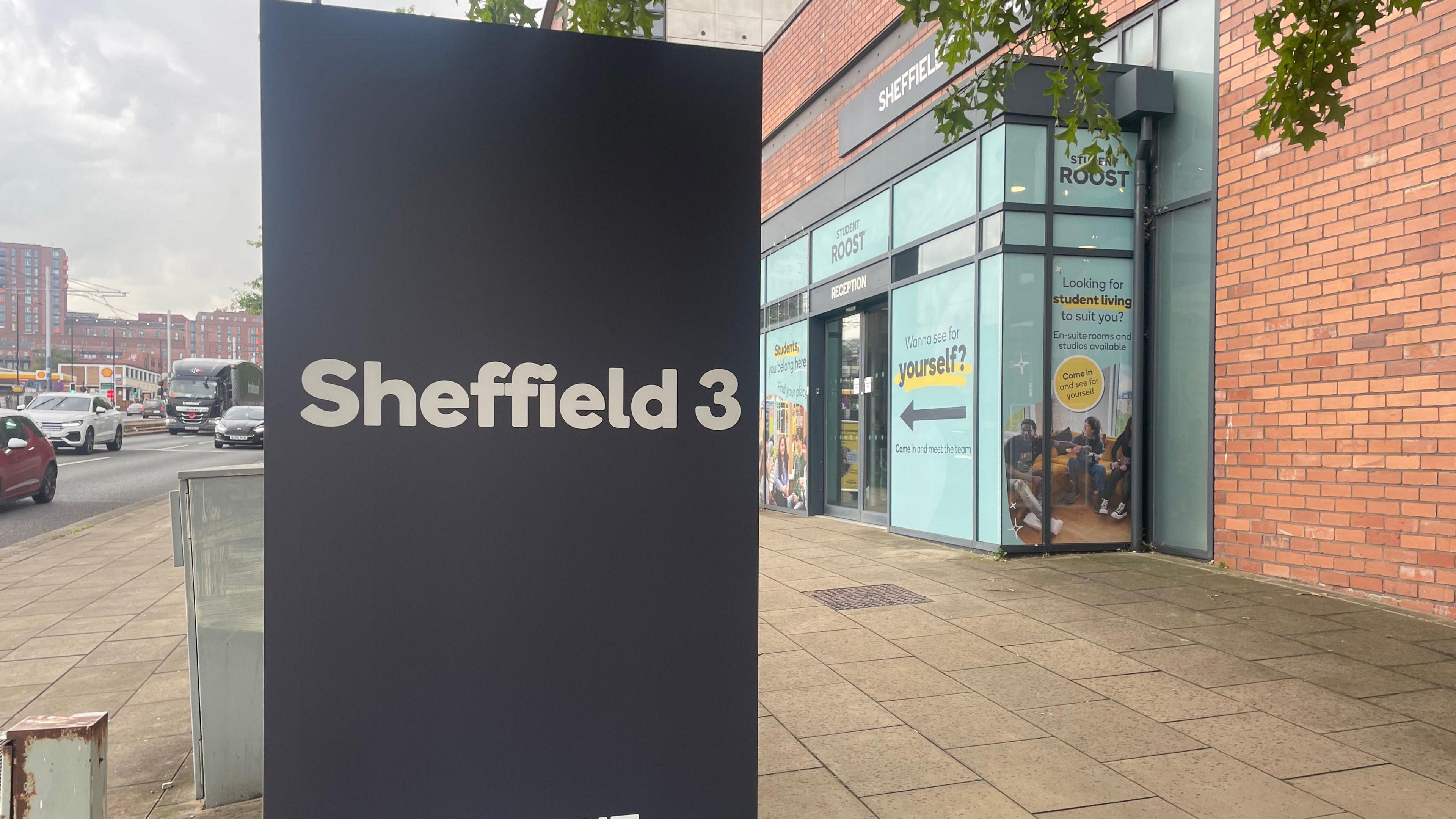 The exterior of a student accommodation block with brightly coloured signage