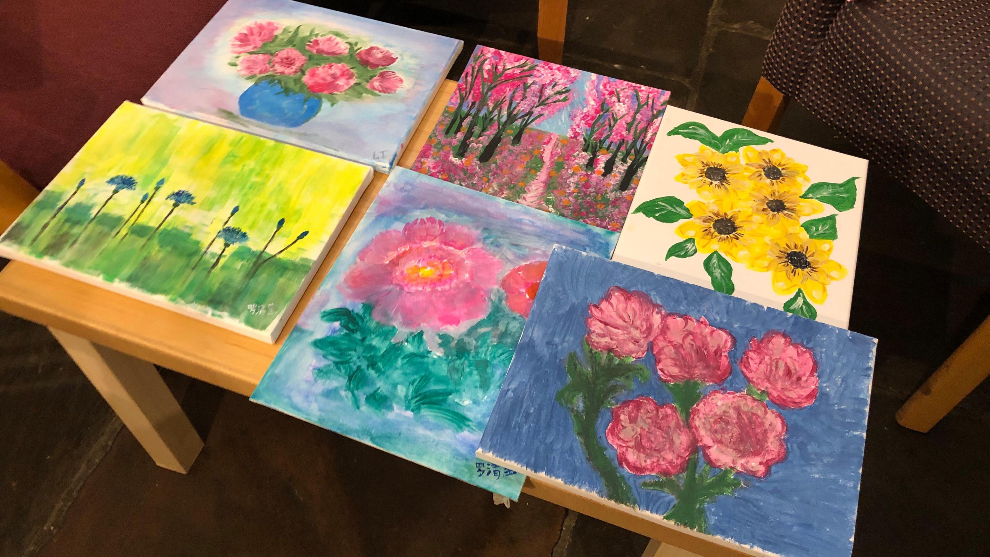 Paintings showing various depictions of flowers