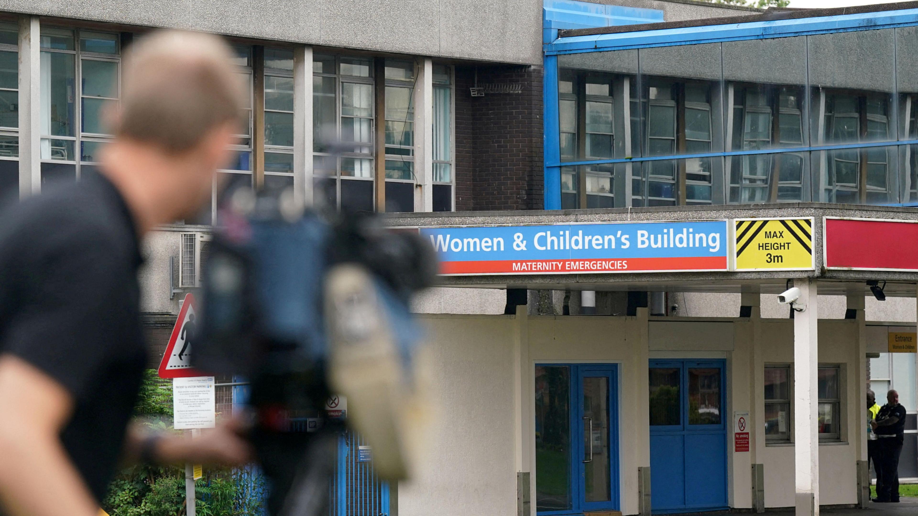 TV cameraman takes shots of women and children's building entrance at Countess of Chester hospital