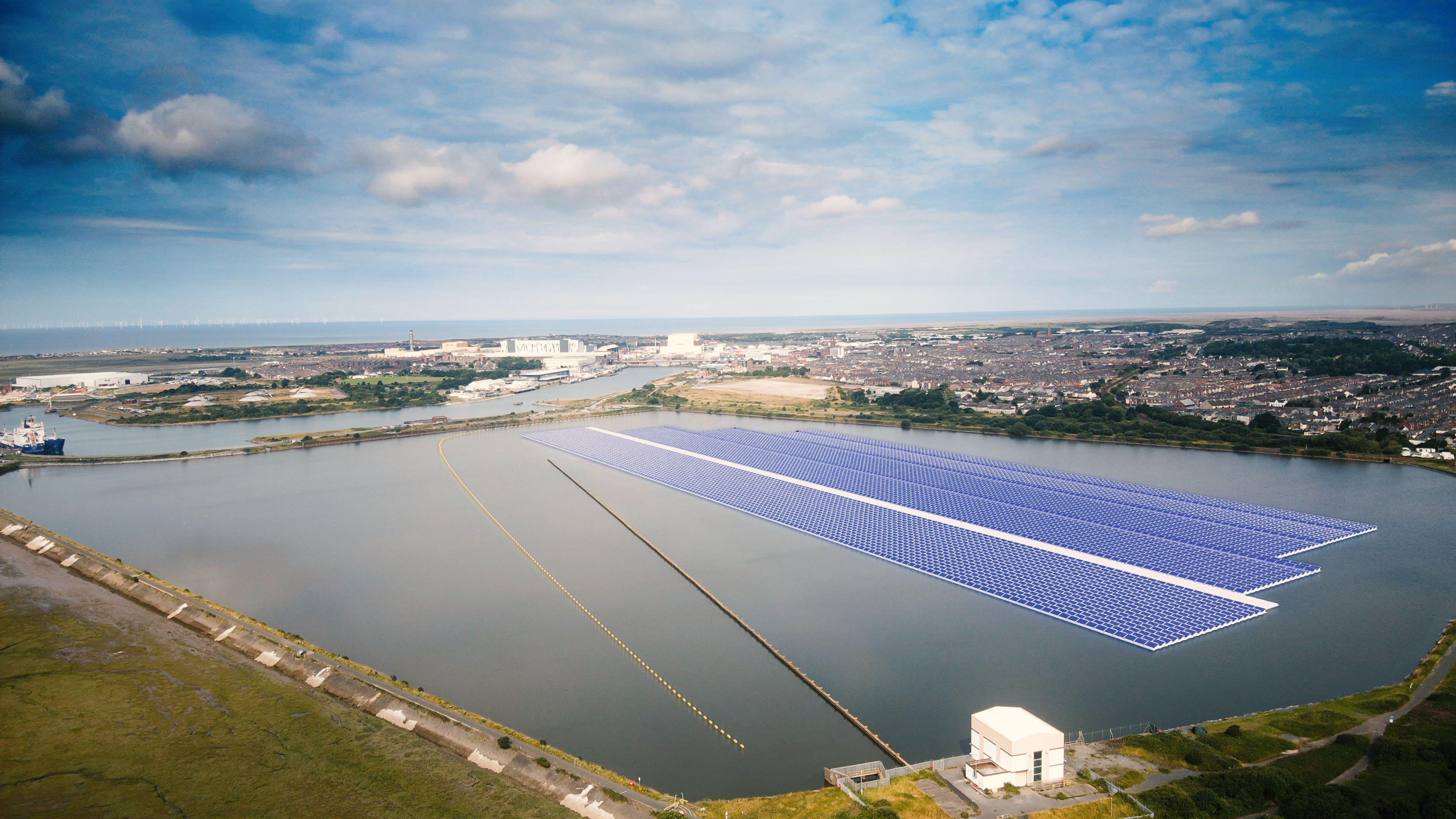 A CGI of how the floating solar farm will look. Three large strips of blue panels are floating across a large section of Cavendish Dock. A town made up of many houses can be seen in the distance.