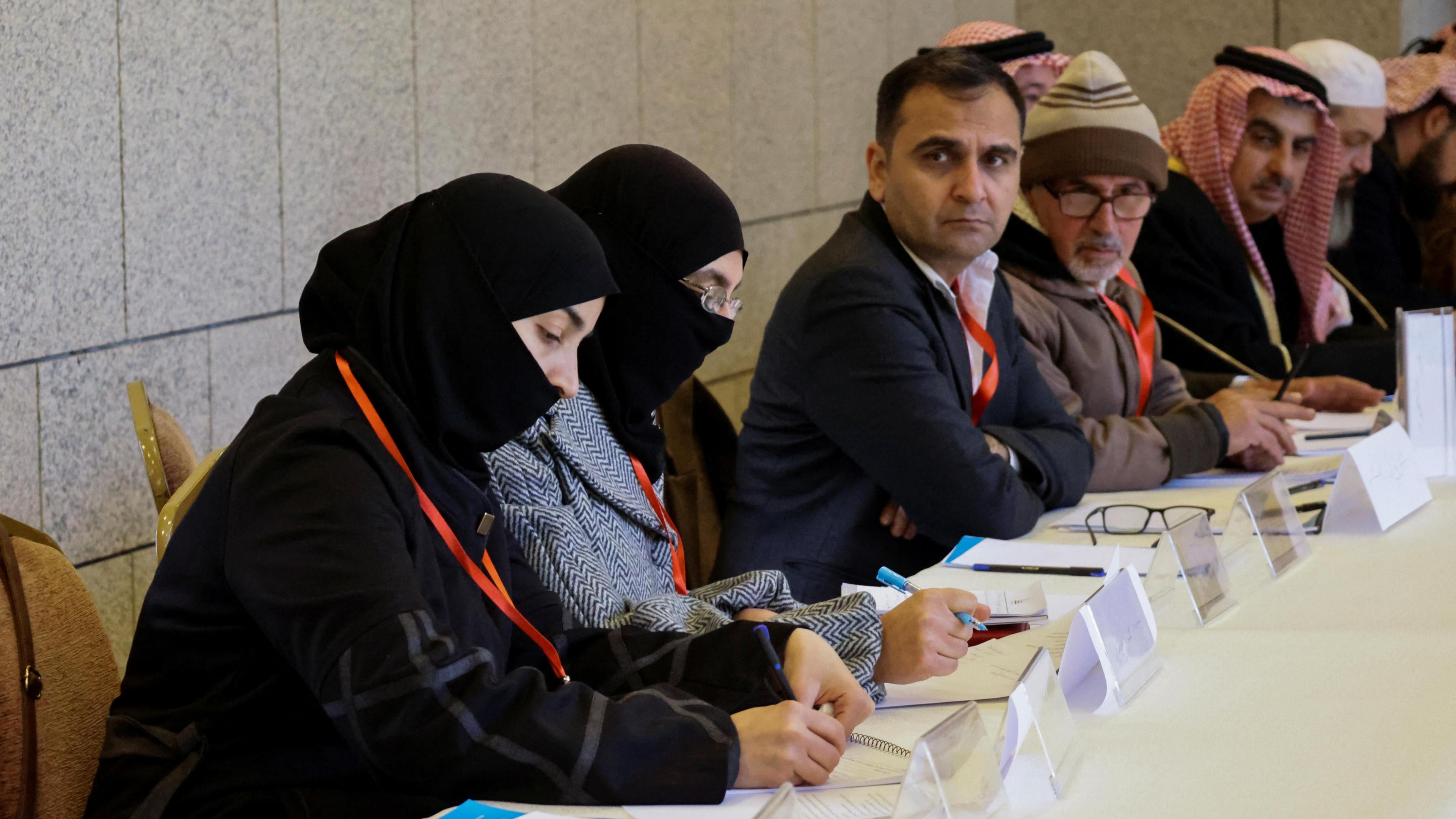 Two women wearing hijab and partial face veils take part in a national dialogue conference in Damascus, Syria (25 February 2025)