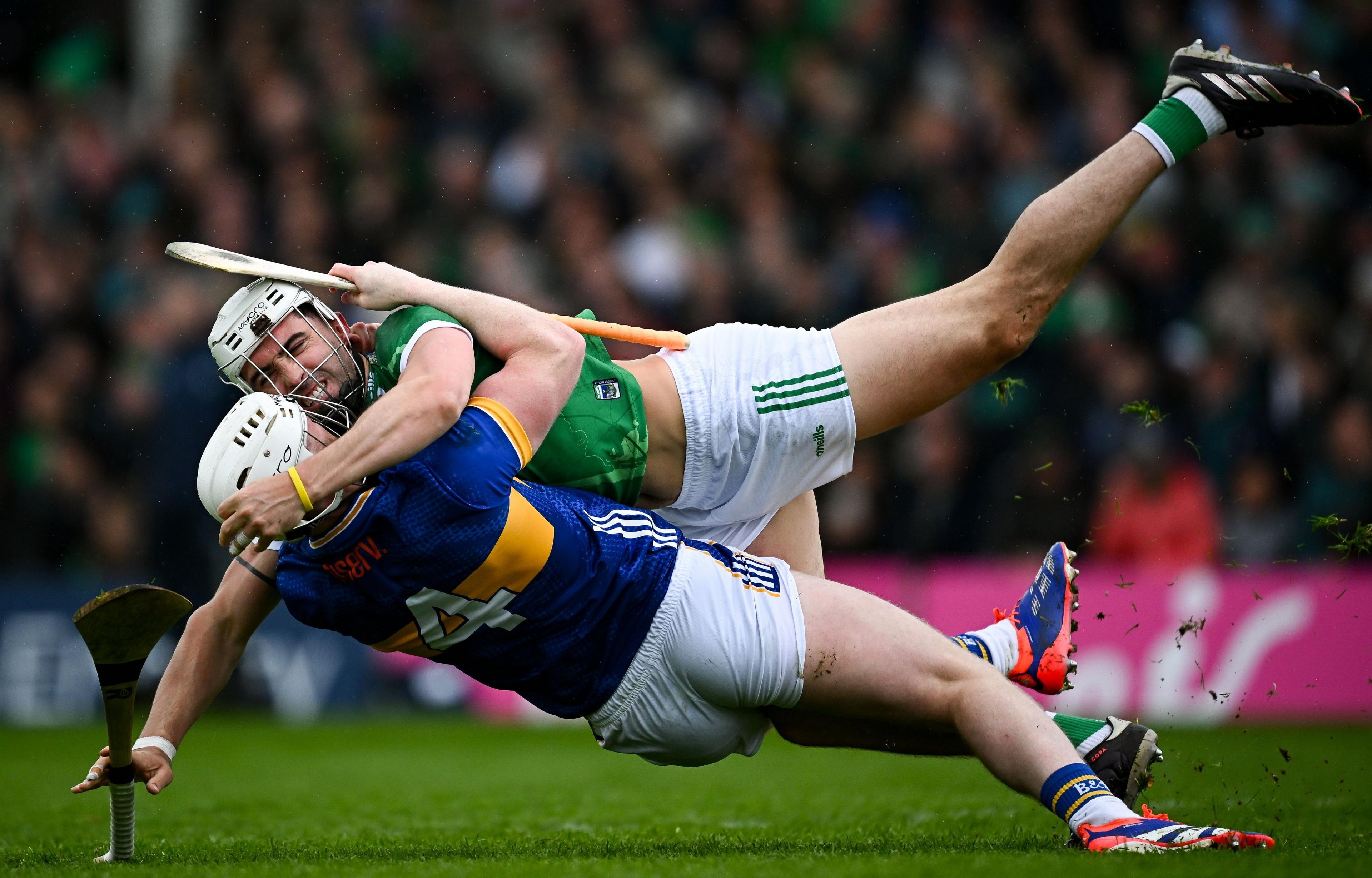 Limerick's Aaron Gillane (top) and Tipperary's Michael Breen fall together during the Munster GAA Hurling Senior Championship in Tipperary