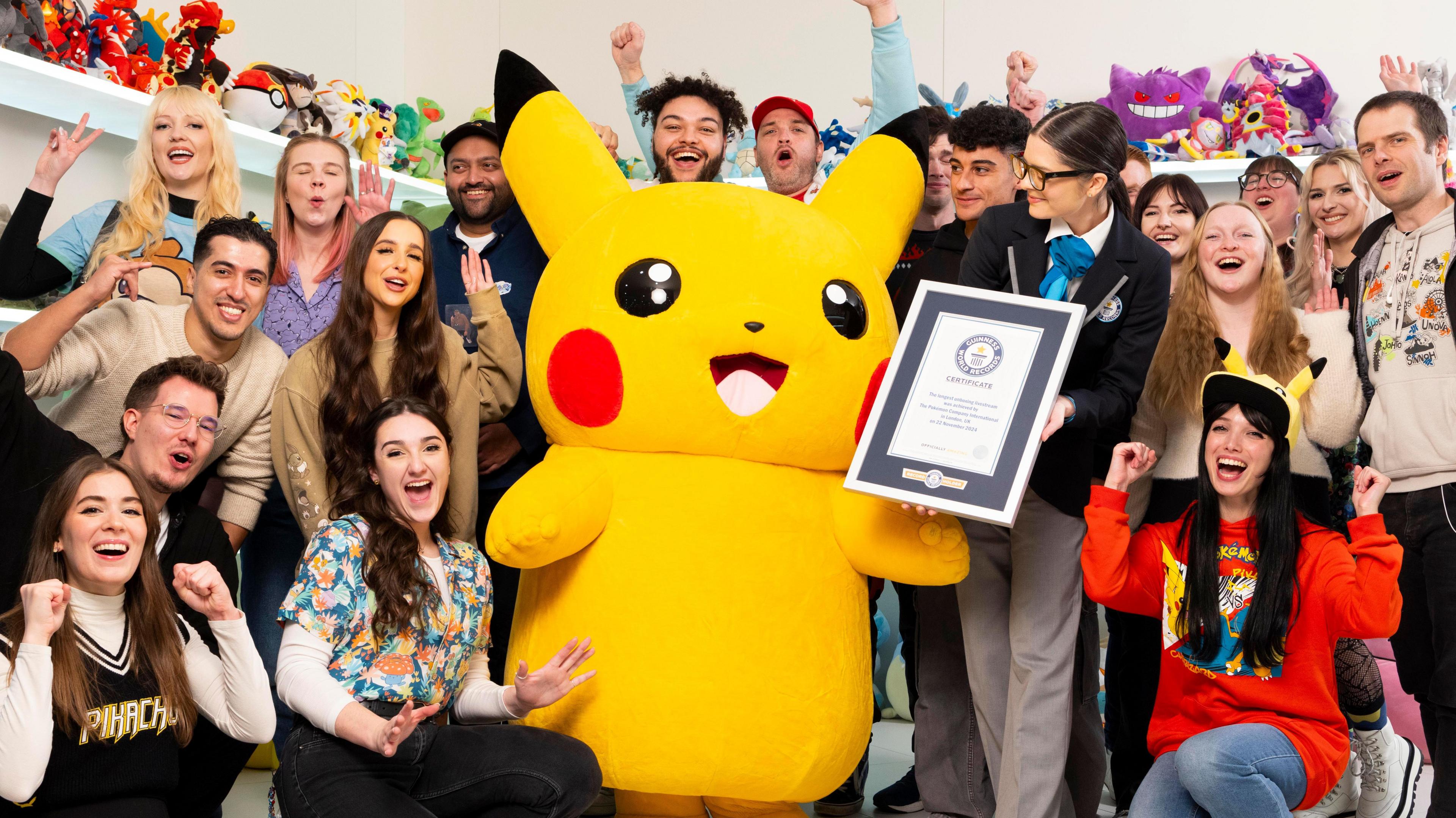 Pokemon fans pose with a representative from Guinness World Records and  Pikachu to celebrate the World Record 