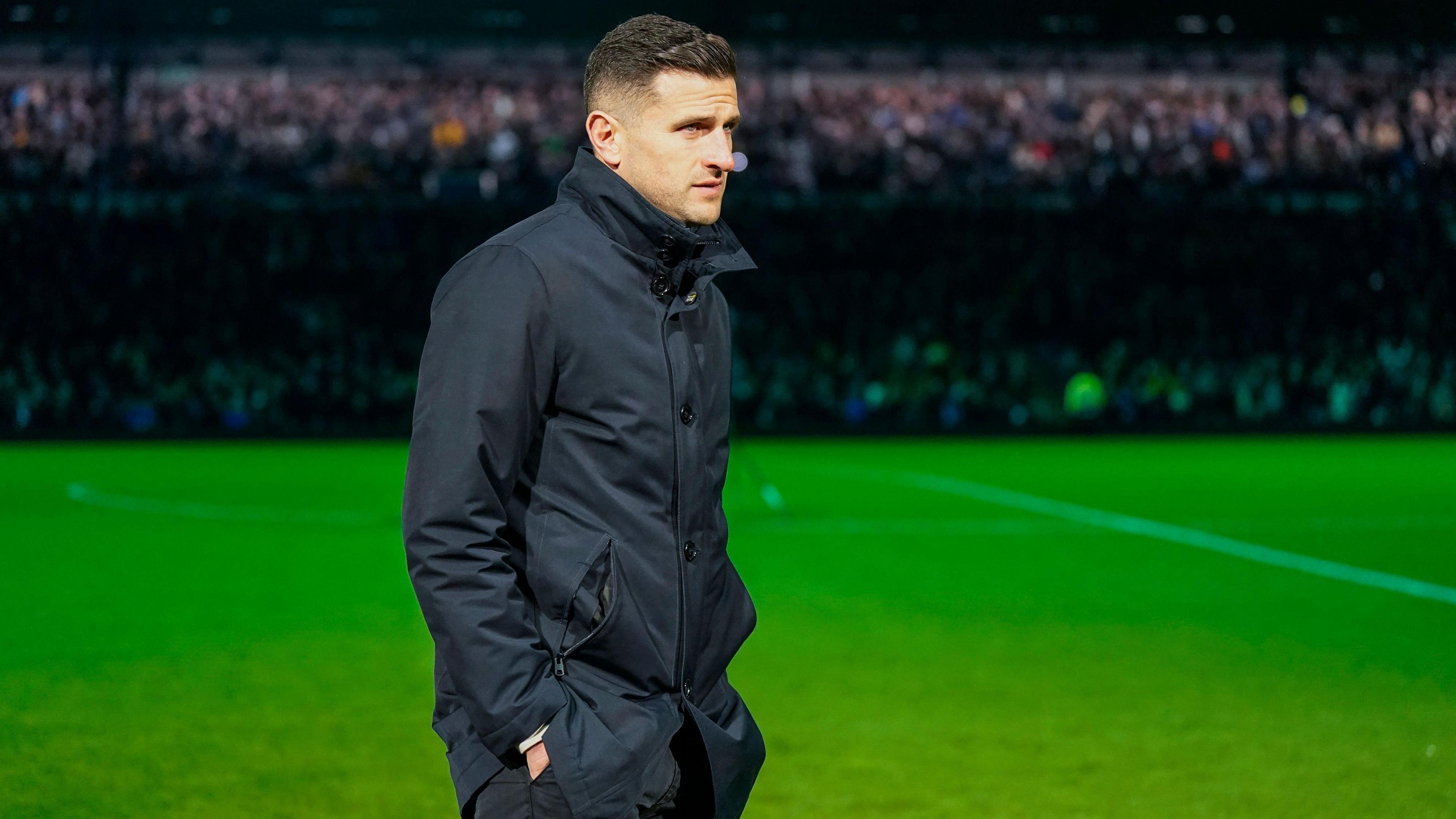 Portsmouth head coach John Mousinho as the stadium lights go out at Fratton Park