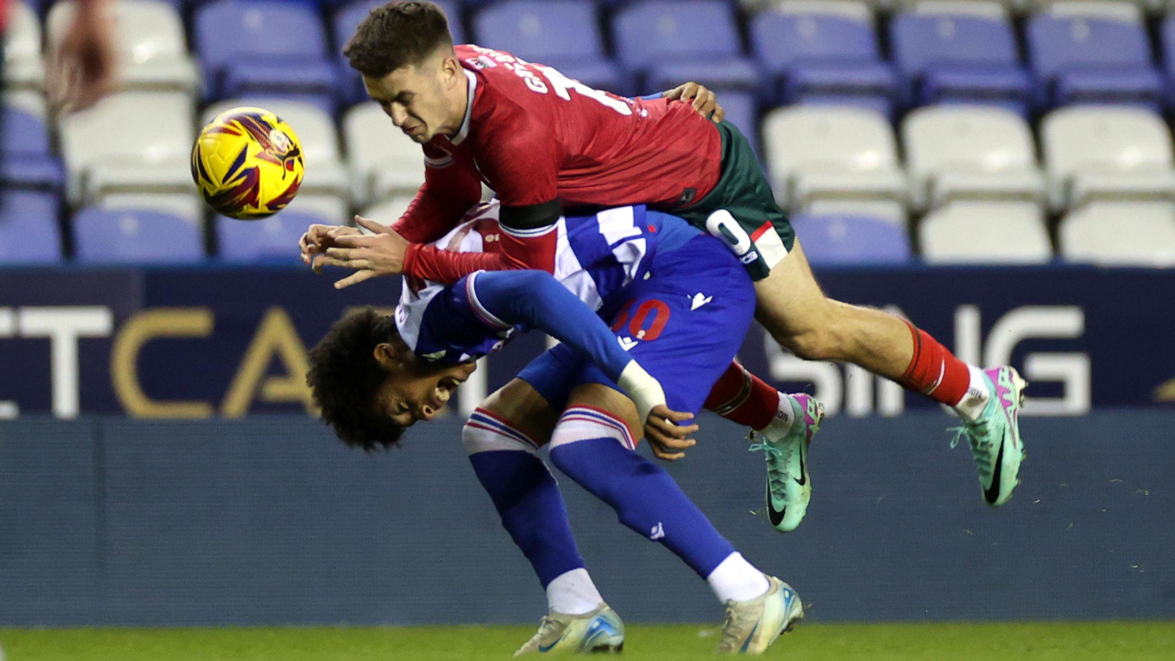 Andre Garcia of Reading is tackled by Oliver Greaves of Newport County