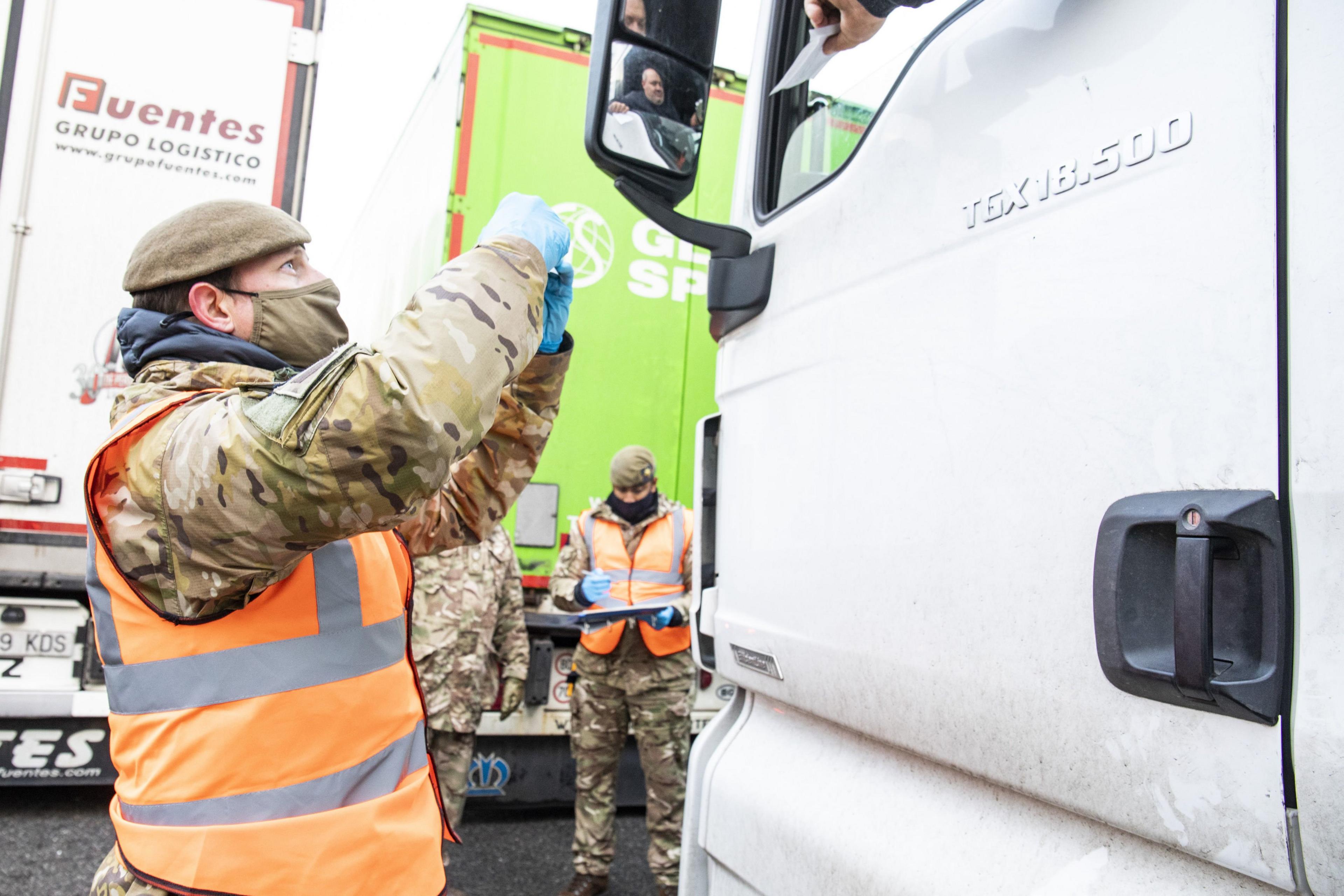 British Army soldier delivering a Covid-19 test to a lorry driver at Manston airfield in Kent on 25 December