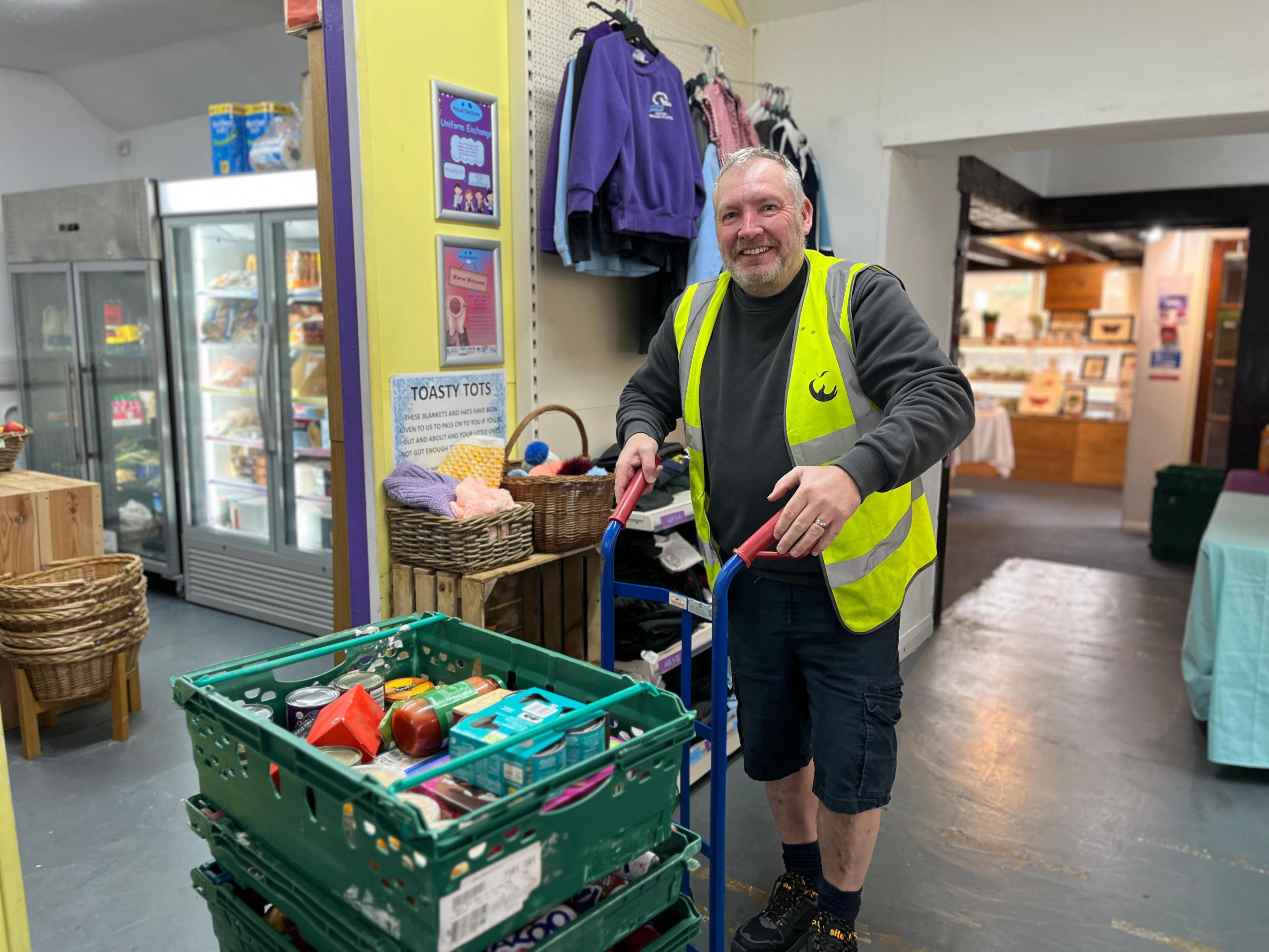 Mark Gardener moving creates of food into the main room at Project40Seven 