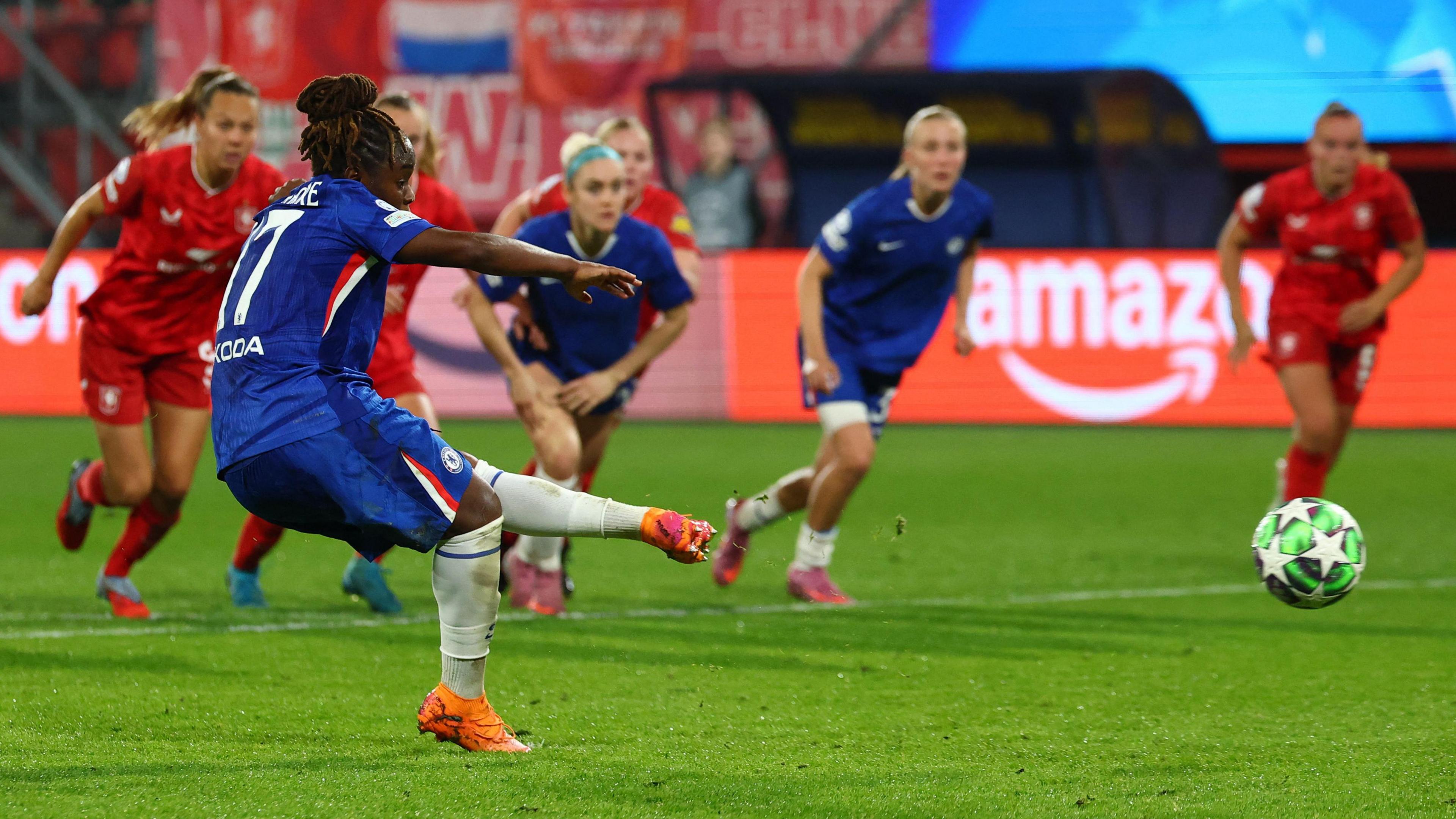 Sandy Baltimore strikes the ball from the penalty spot with her left foot
