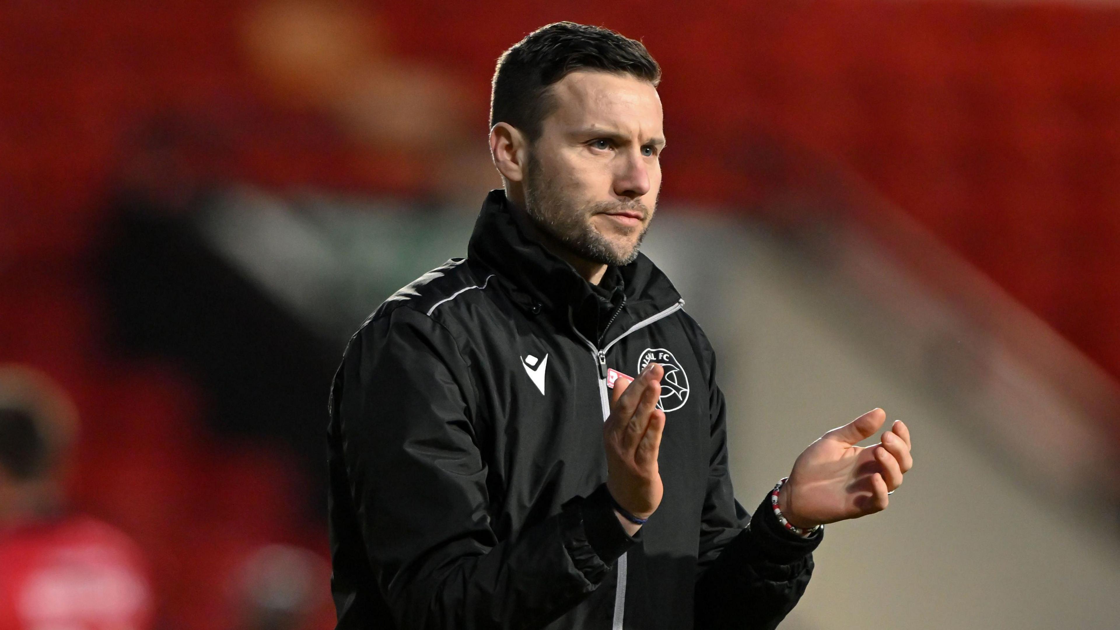 Walsall head coach Mat Sadler claps his players during a game