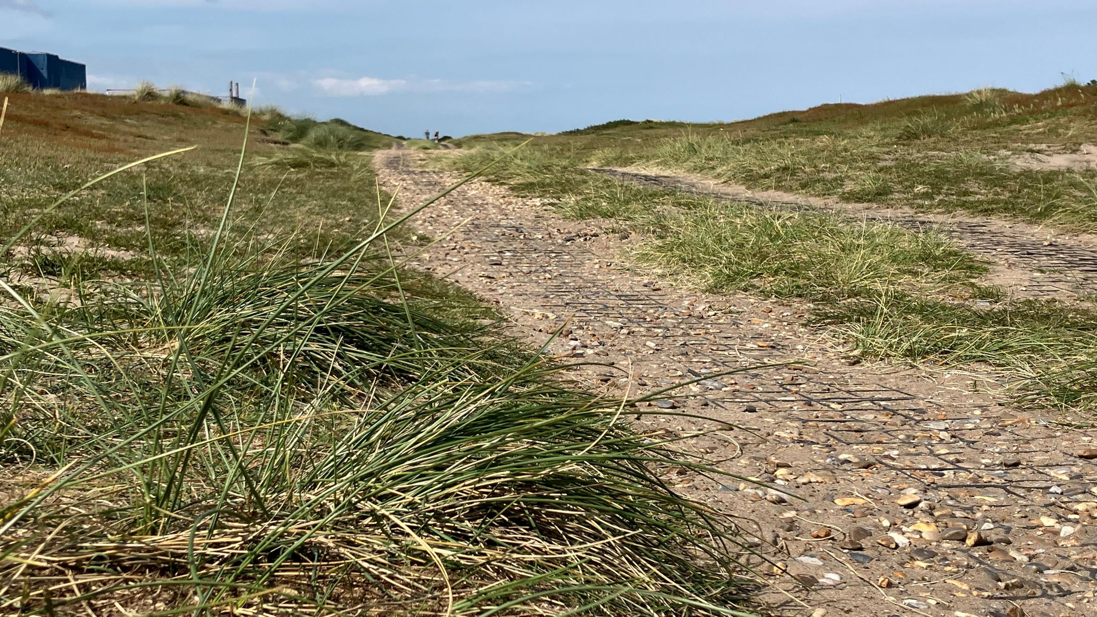 Close up view of the footpath running in front of Sizewell B power station along the beach  