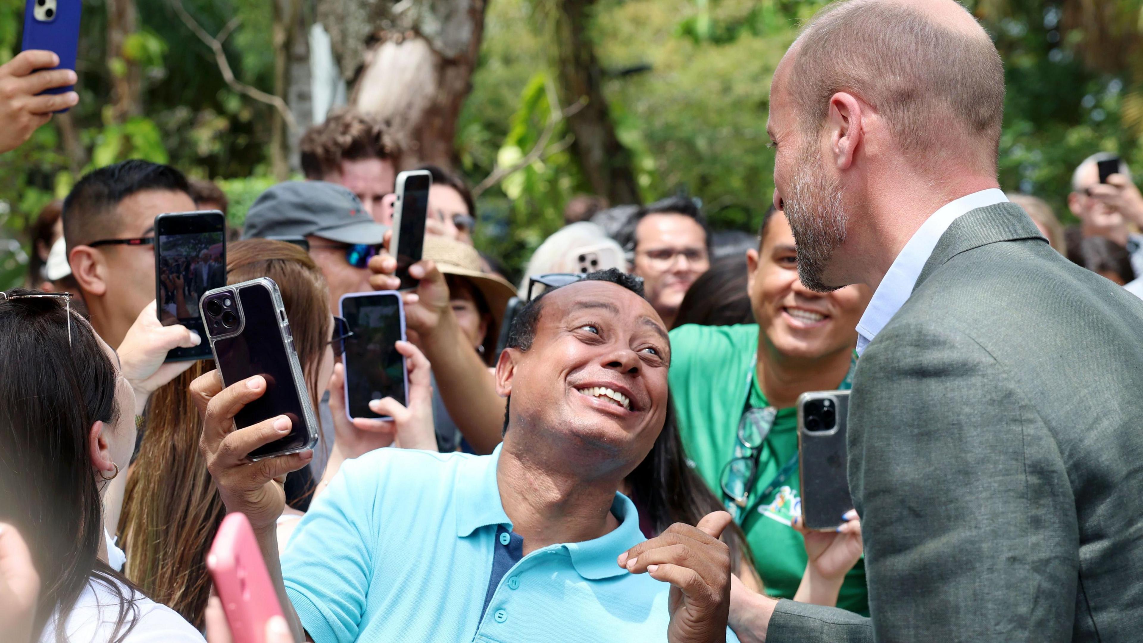 The Prince of Wales poses for pictures with members of the public during a Welcome to Rio event at Sugarloaf Mountain, in Rio de Janeiro