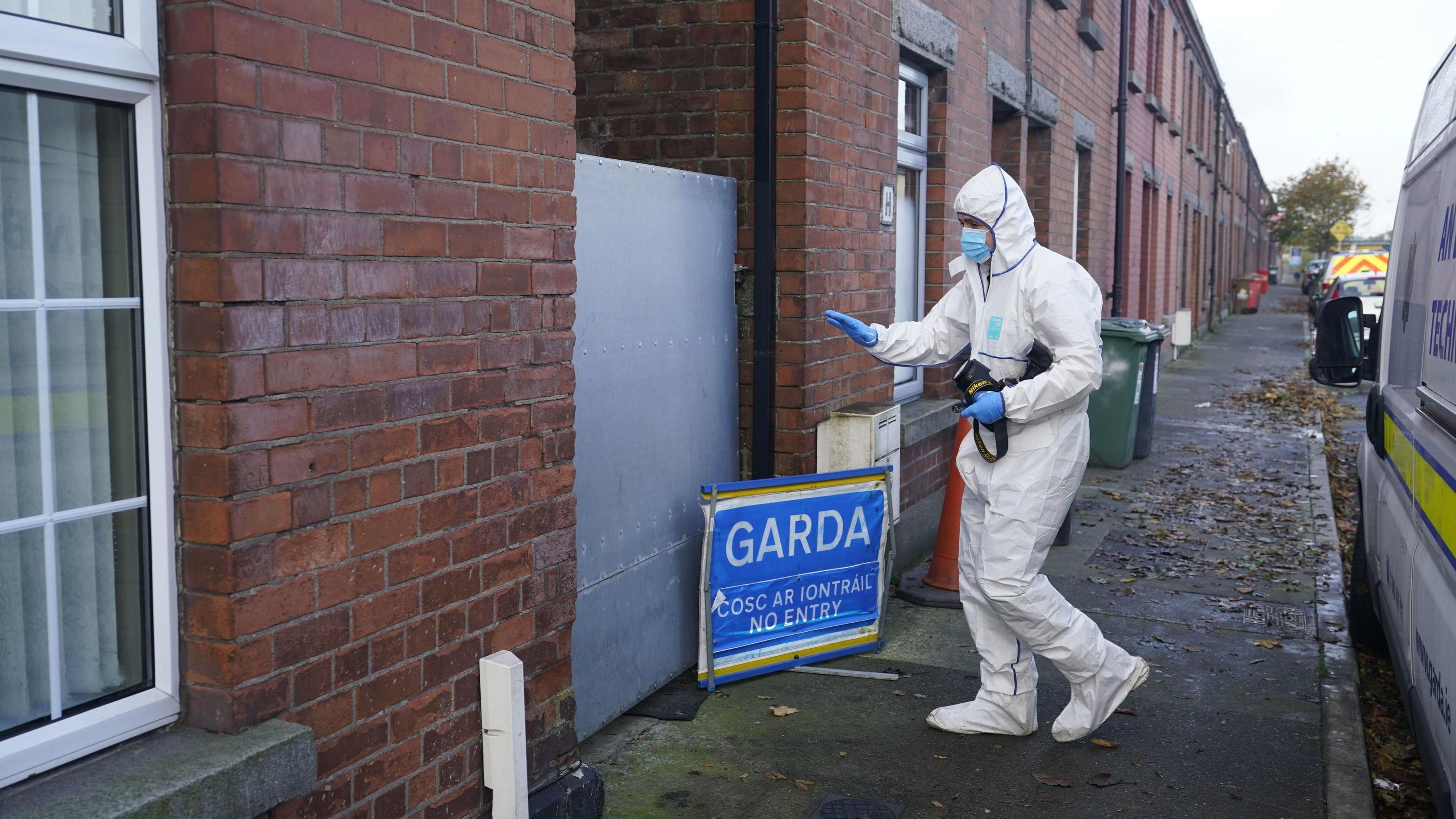 A masked Gardai forensic officer in Dundalk pictured during a search of a house linked to the investigation into the suspected murder of eight-year-old Kyran Durnin