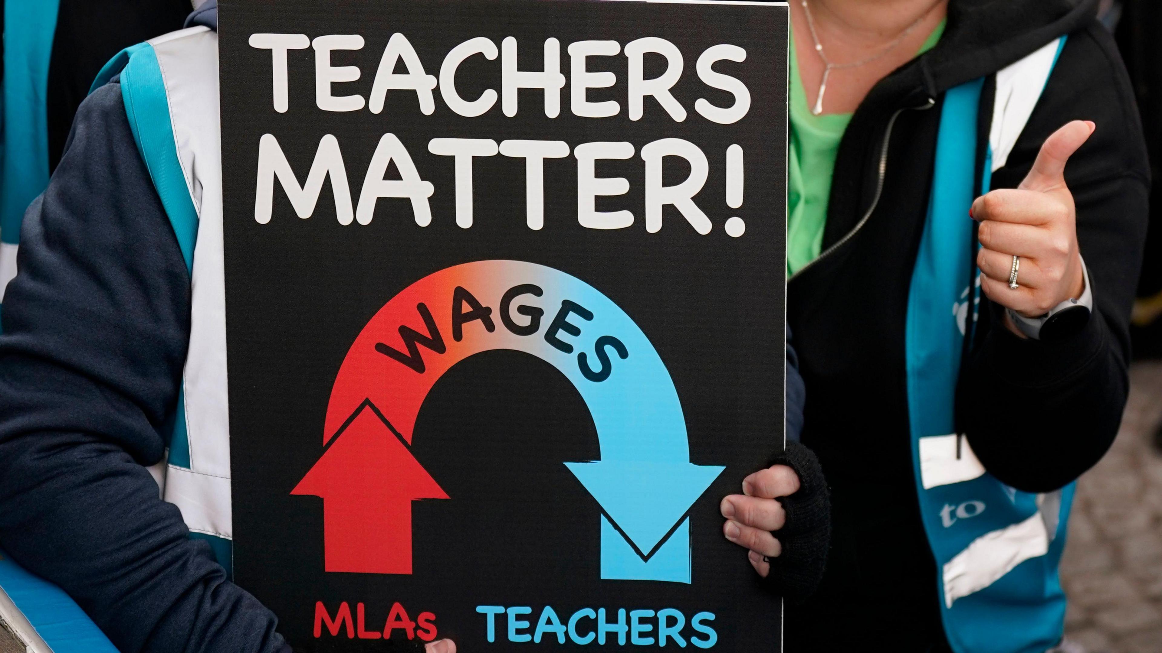 A placard that says 'teachers matter' 