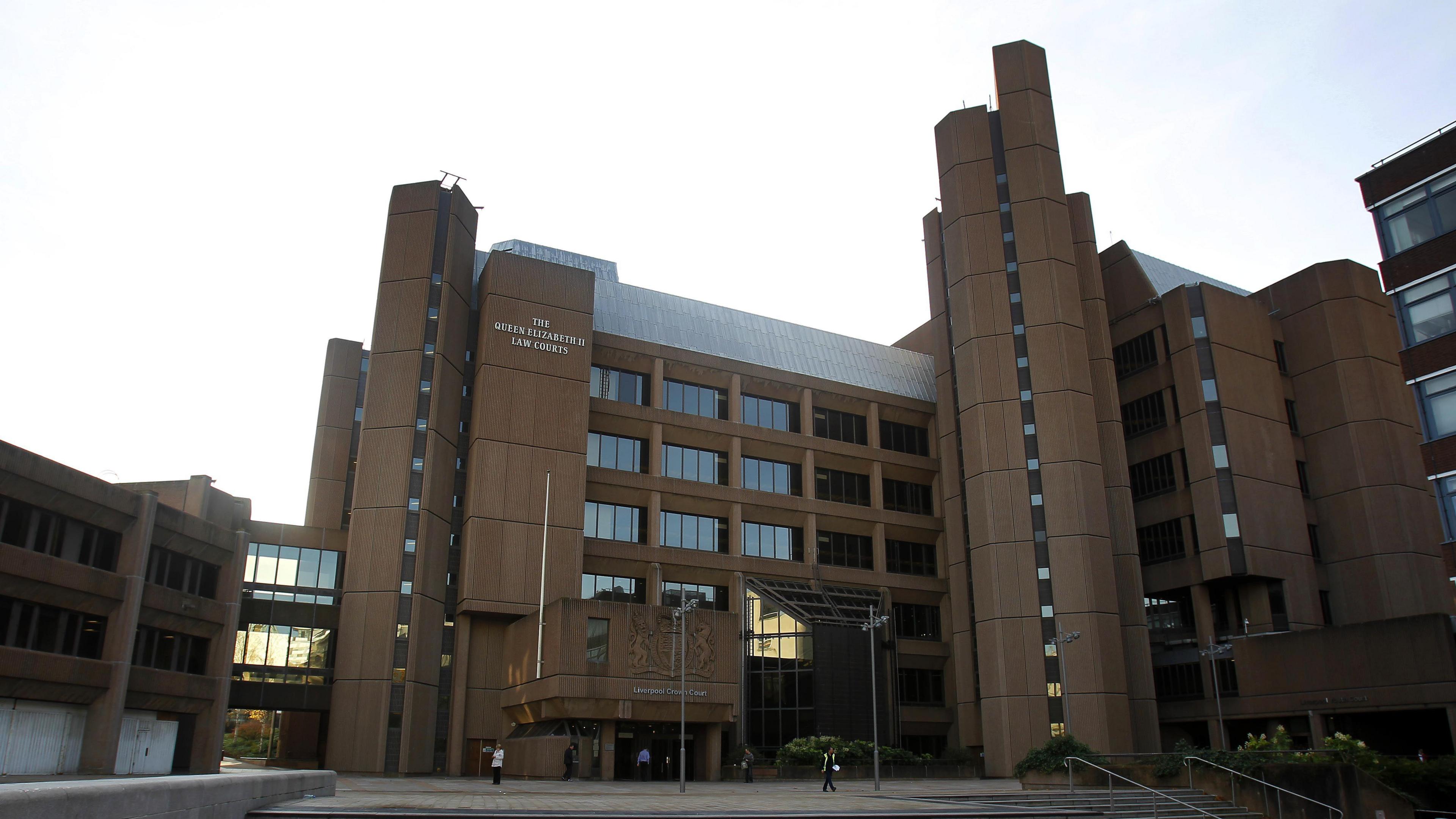 Liverpool Crown Court, which is a brown concrete building with a glass lobby area. 