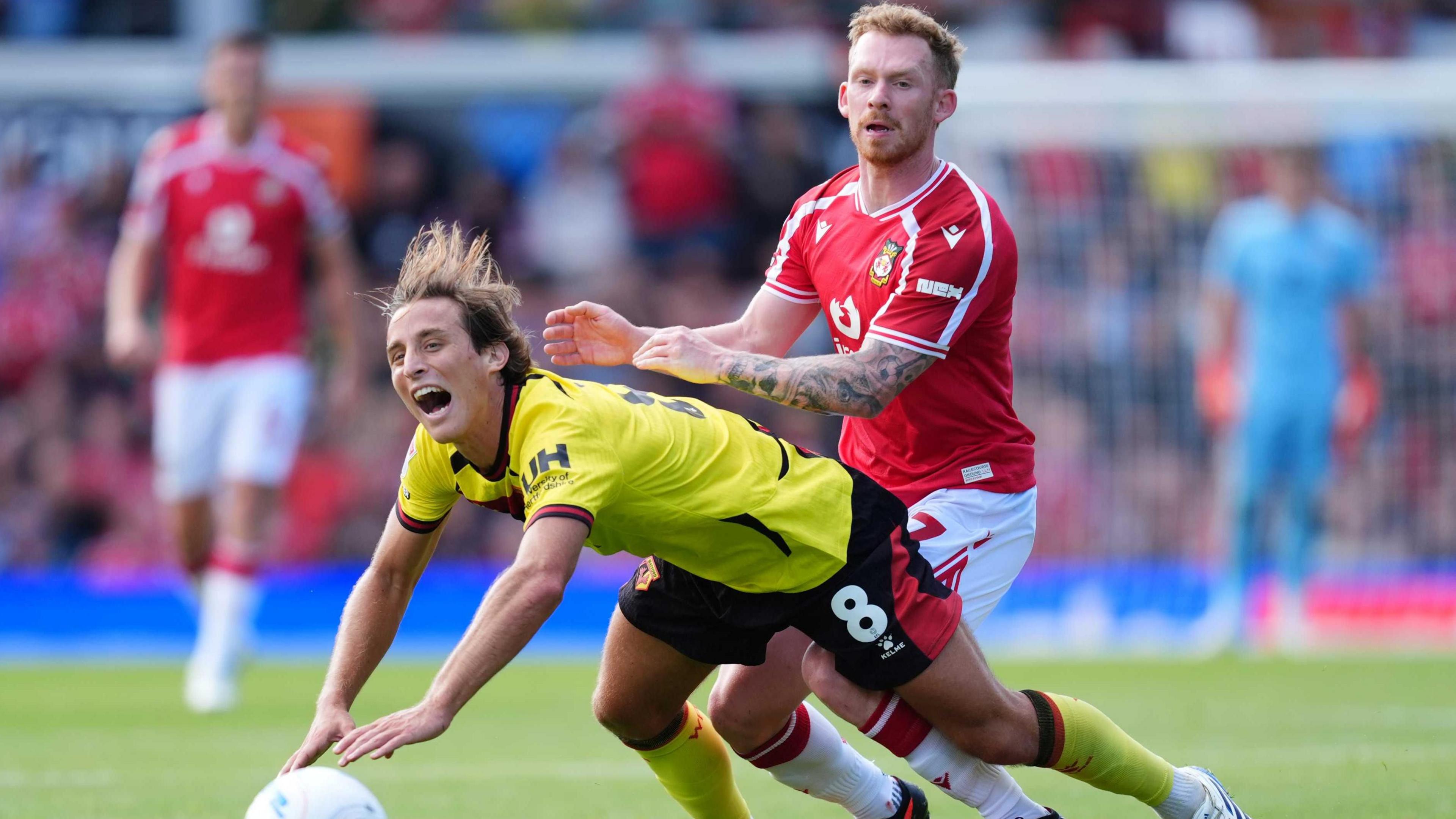 Watford's Edoardo Bove (left) and Wrexham's Lewis O'Brien battle for the ball