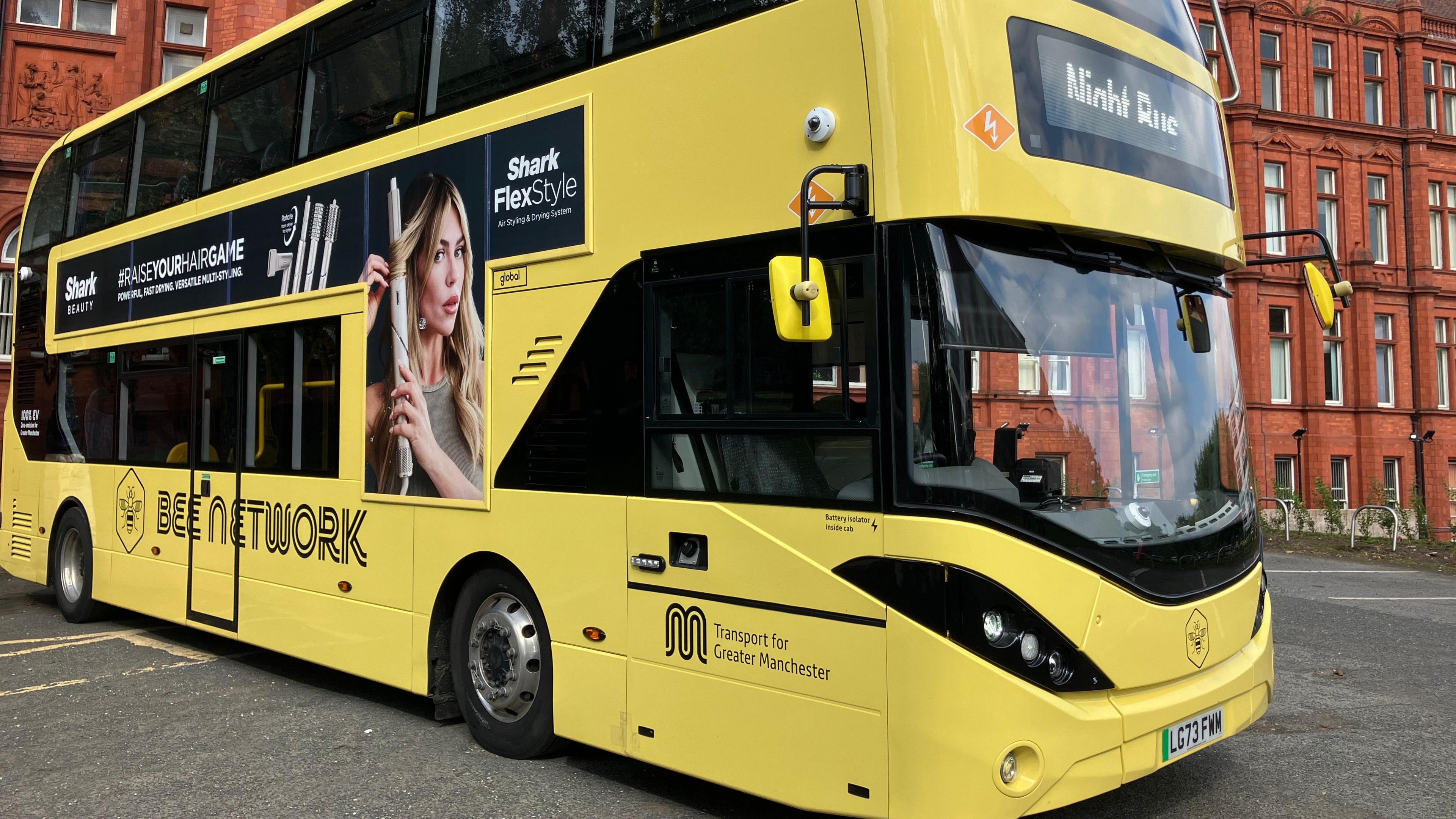 A bright yellow double decker bus bearing the Bee Network livery