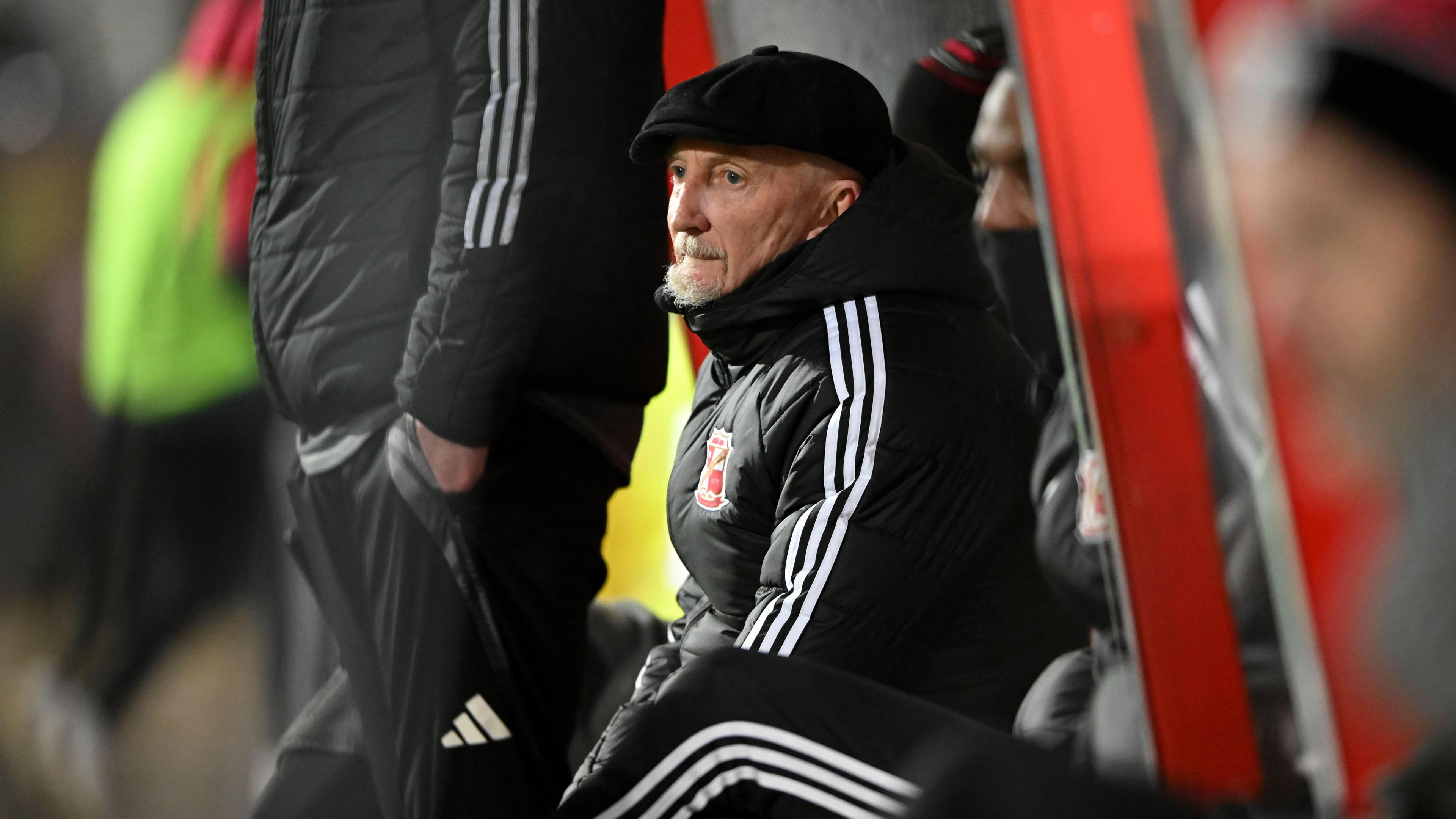 Ian Holloway watching the match action as he sits in the dugout during a game last season