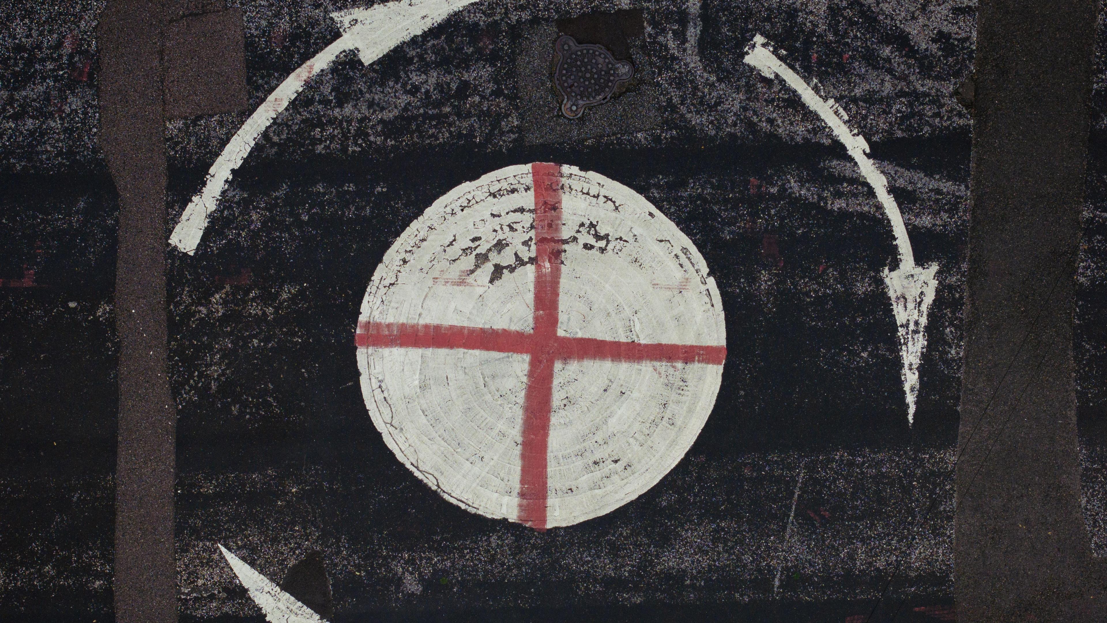 The cross of St George daubed on a mini-roundabout, pictured from above.